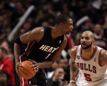 CHICAGO, IL - FEBRUARY 24: Chris Bosh #1 of the Miami Heat looks to moves against Carlos Boozer #5 of the Chicago Bulls at the United Center on February 24, 2011 in Chicago, Illinois. The Bulls defeated the Heat 93-89. NOTE TO USER: User expressly acknowl