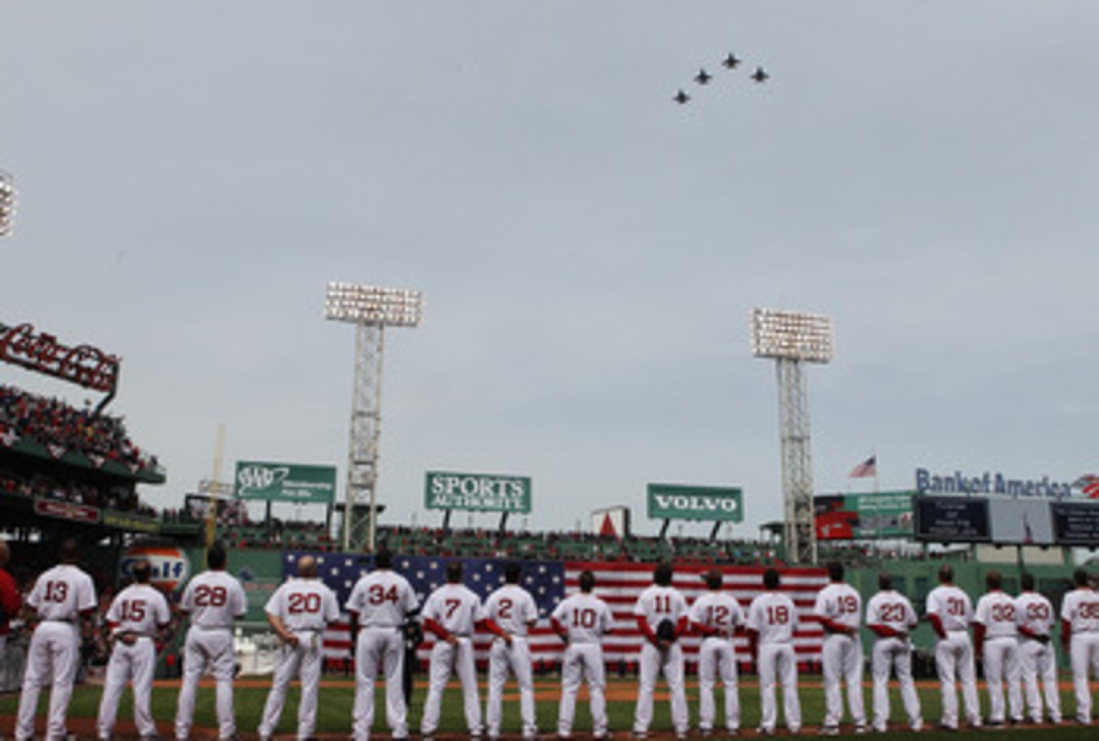BOSTON, MA - APRIL 8:   Members of the Boston Red Sox stand during pregame flyover before a game with the New York Yankees during Opening Day at Fenway Park on April 8, 2011 in Boston, Massachusetts. (Photo by Jim Rogash/Getty Images)