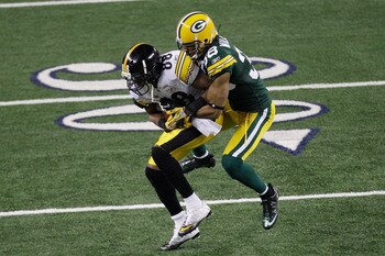 ARLINGTON, TX - FEBRUARY 06:  Emmanuel Sanders #88 of the Pittsburgh Steelers catches a 13 yard pass for a first down against Tramon Williams #38 of the Green Bay Packers in the second quarter of Super Bowl XLV at Cowboys Stadium on February 6, 2011 in Ar