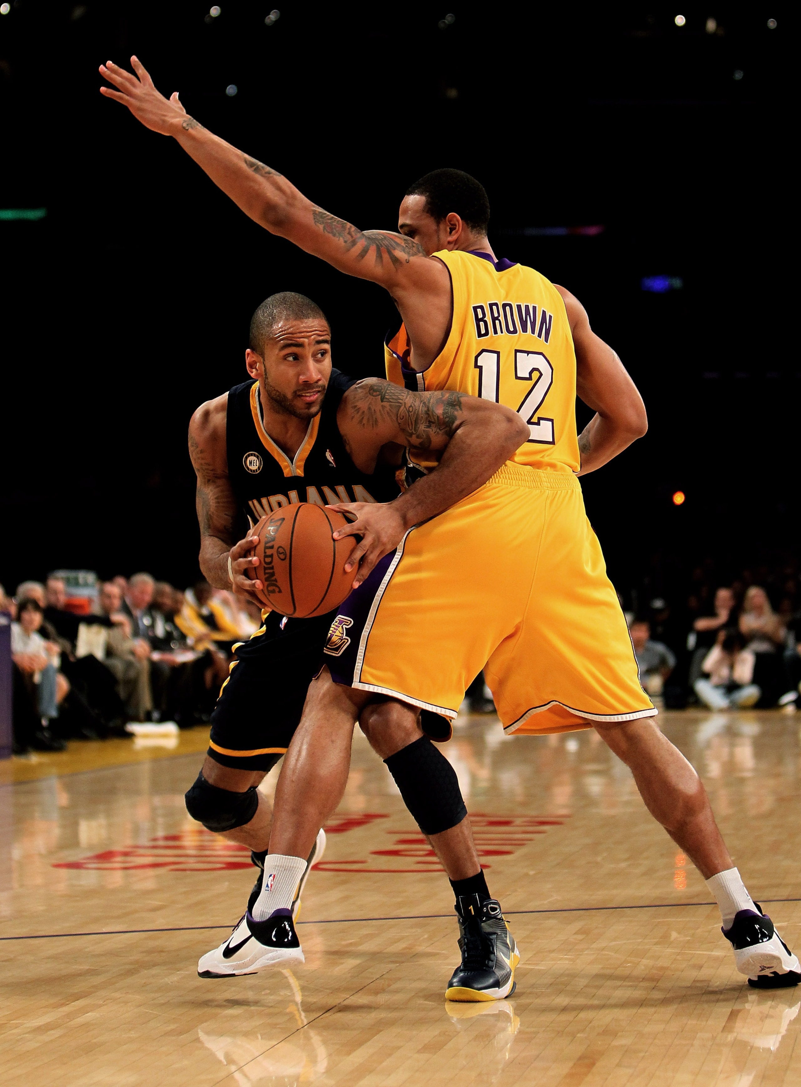 LOS ANGELES, CA - MARCH 02:  Dahntay Jones #1 of the Indiana Pacers drives against Shannon Brown #12 of the Los Angeles Lakers on March 2, 2010 at Staples Center in Los Angeles, California. The Lakers won 122-99.  NOTE TO USER: User expressly acknowledges