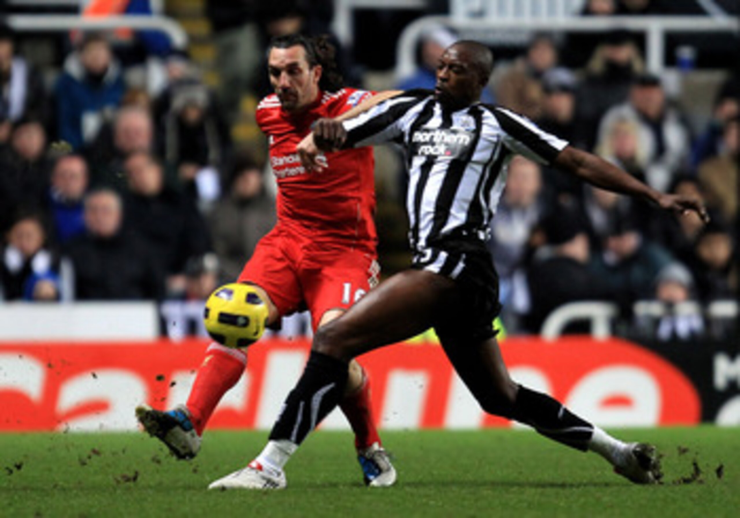 NEWCASTLE, UNITED KINGDOM - DECEMBER 11: Sotirios Kyrgiakos of Liverpool challenges Shola Ameobi of Newcastle United during the Barclays Premier League match between Newcastle United and Liverpool at St James' Park on December 11, 2010 in Newcastle, Engl NEWCASTLE, UNITED KINGDOM - DECEMBER 11: Sotirios Kyrgiakos of Liverpool challenges Shola Ameobi of Newcastle United during the Barclays Premier League match between Newcastle United and Liverpool at St James' Park on December 11, 2010 in Newcastle, Engl