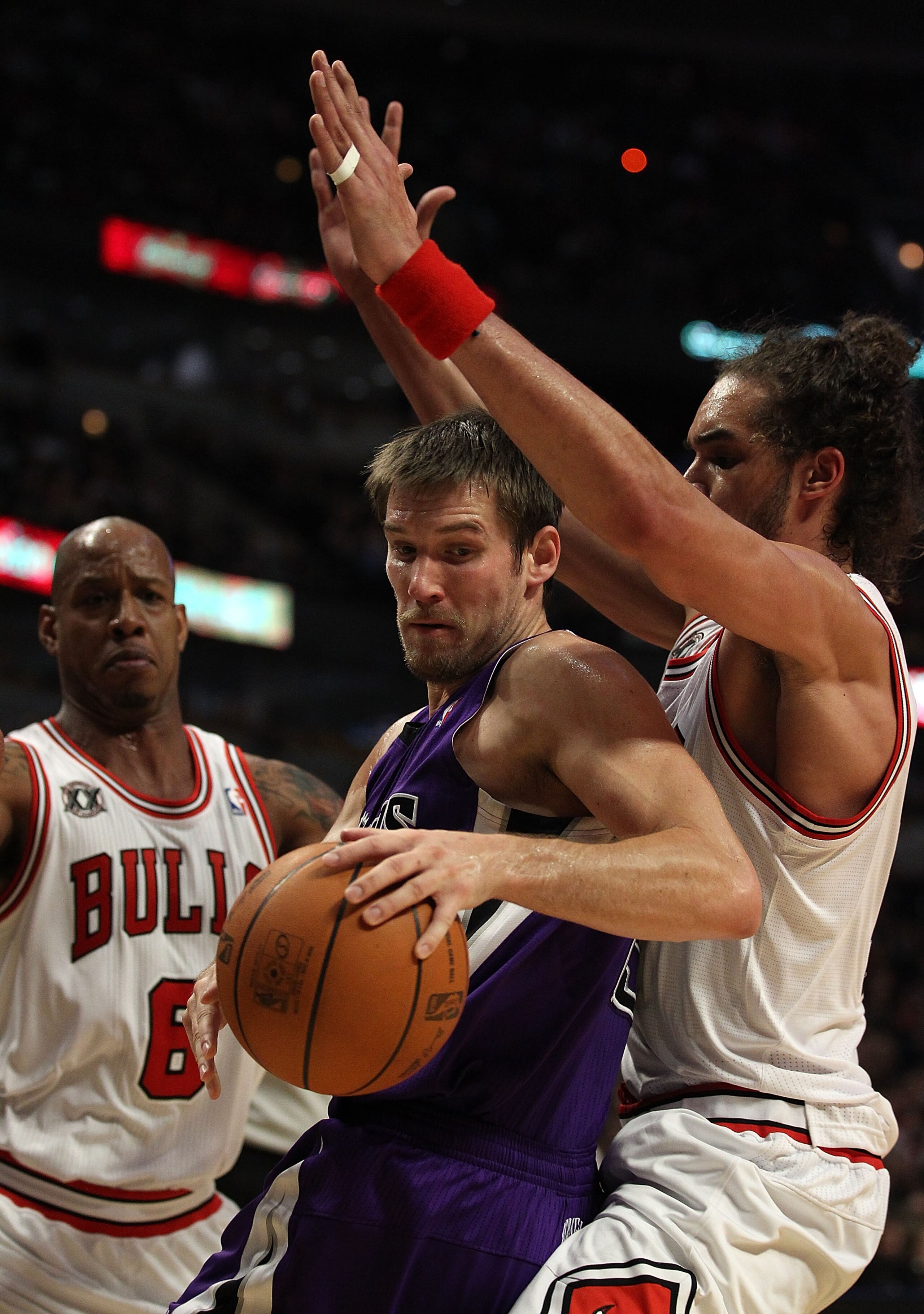 CHICAGO, IL - MARCH 21: Beno Udrih #19 of the Sacramento Kings tries to move under pressure from Joakim Noah #13 and Keith Bogans #6 of the Chicago Bulls at the United Center on March 21, 2011 in Chicago, Illinois. The Bulls defeated the Kings 132-92. NOT