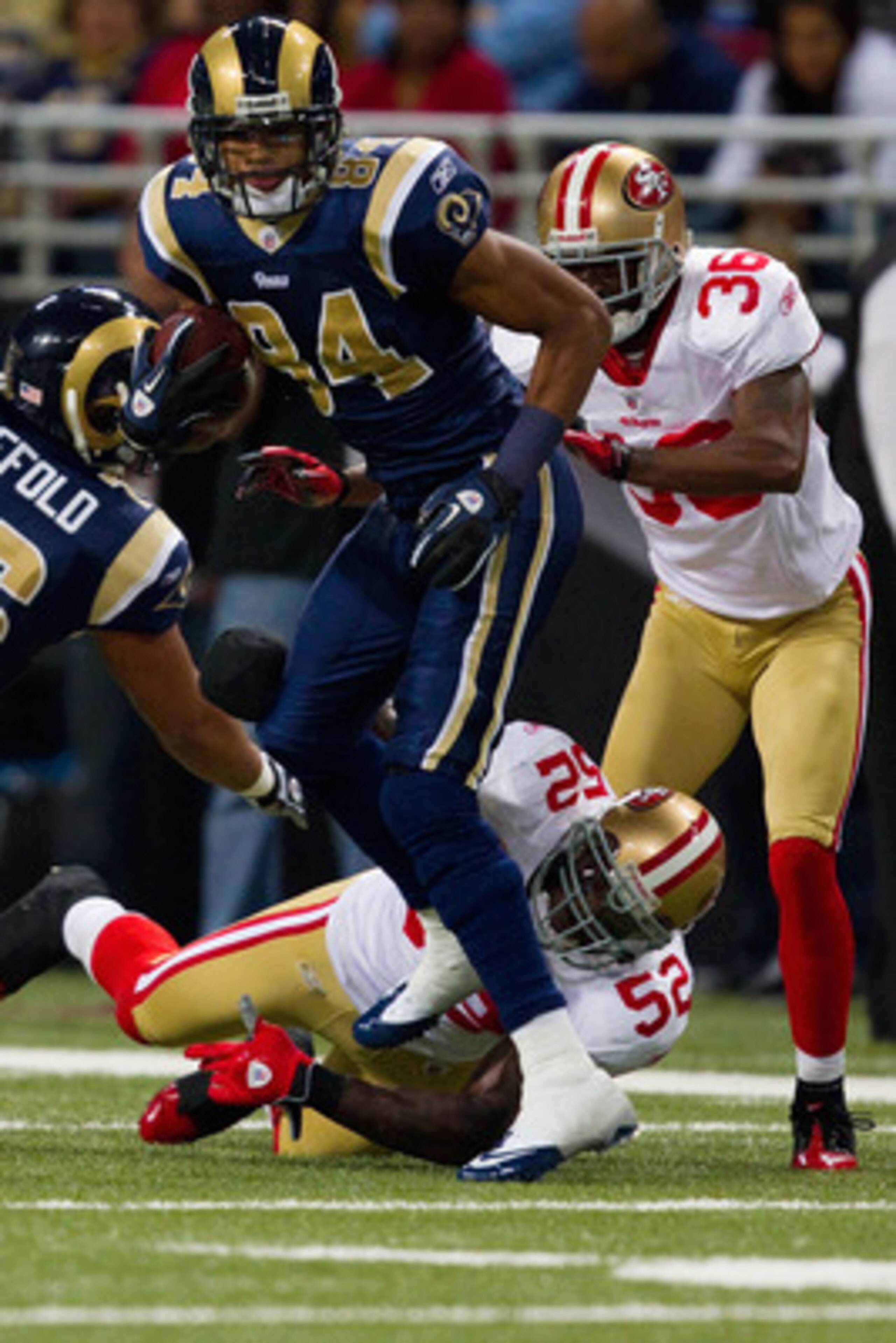 ST. LOUIS, MO - DECEMBER 26: Danario Alexander #84 of the St. Louis Rams slips out a tackle attempt by Patrick Willis #52 of the San Francisco 49ers at the Edward Jones Dome on December 26, 2010 in St. Louis, Missouri. The Rams beat the 49ers 25-17. (Phot