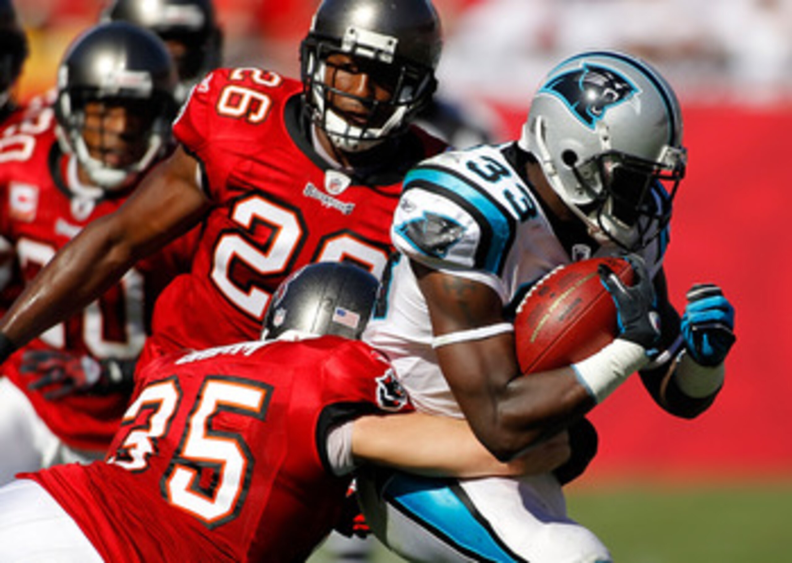TAMPA, FL - NOVEMBER 14:  Safety Cody Grimm #35 of the Tampa Bay Buccaneers tackles running back Mike Goodson #33 of the Carolina Panthers during the game at Raymond James Stadium on November 14, 2010 in Tampa, Florida.  (Photo by J. Meric/Getty Images)