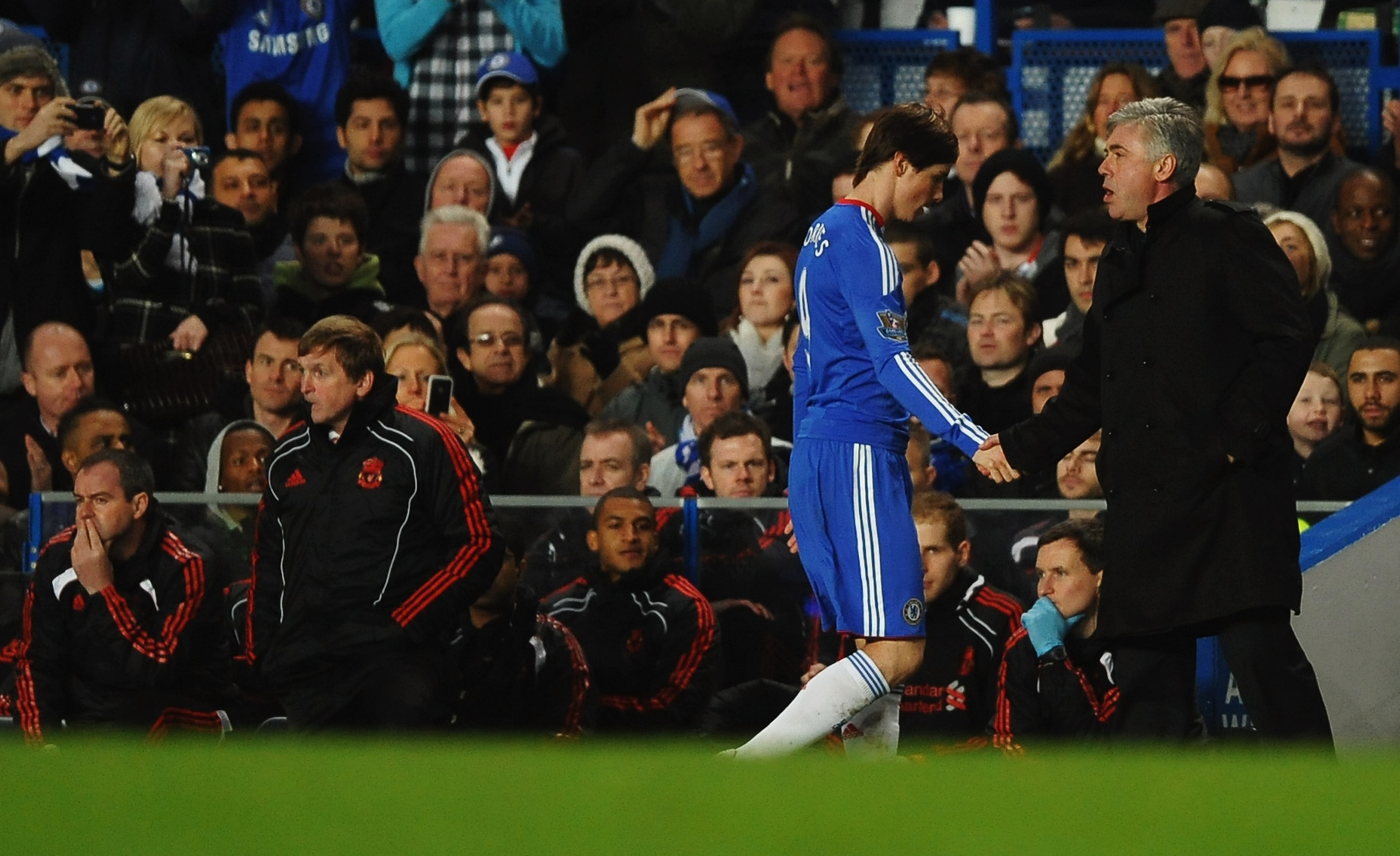 LONDON, ENGLAND - FEBRUARY 06:  Fernando Torres of Chelsea shakes hands with Carlo Ancelotti manager of Chelsea as he is substituted while Kenny Dalglish manager of Liverpool looks on during the Barclays Premier League match between Chelsea and Liverpool