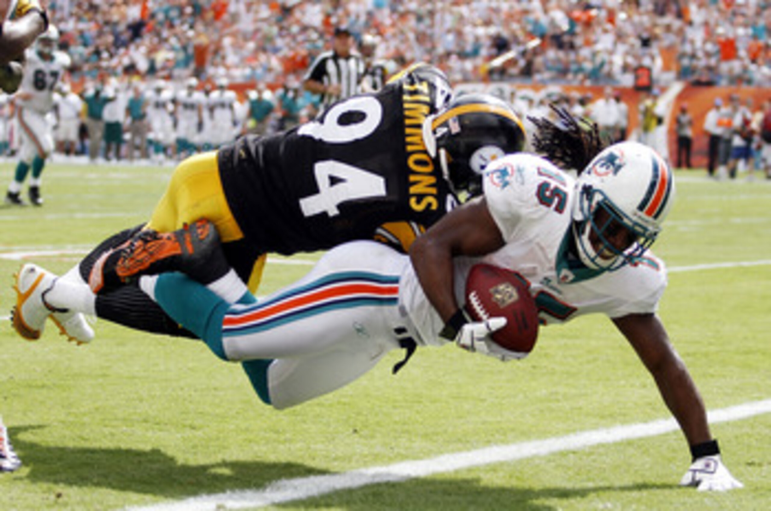 MIAMI - OCTOBER 24:  Receiver Davone Bess #15 scores a touchdown against linebacker Lawrence Timmons #94 of the Pittsburgh Steelers  at Sun Life Stadium on October 24, 2010 in Miami, Florida.  (Photo by Marc Serota/Getty Images)