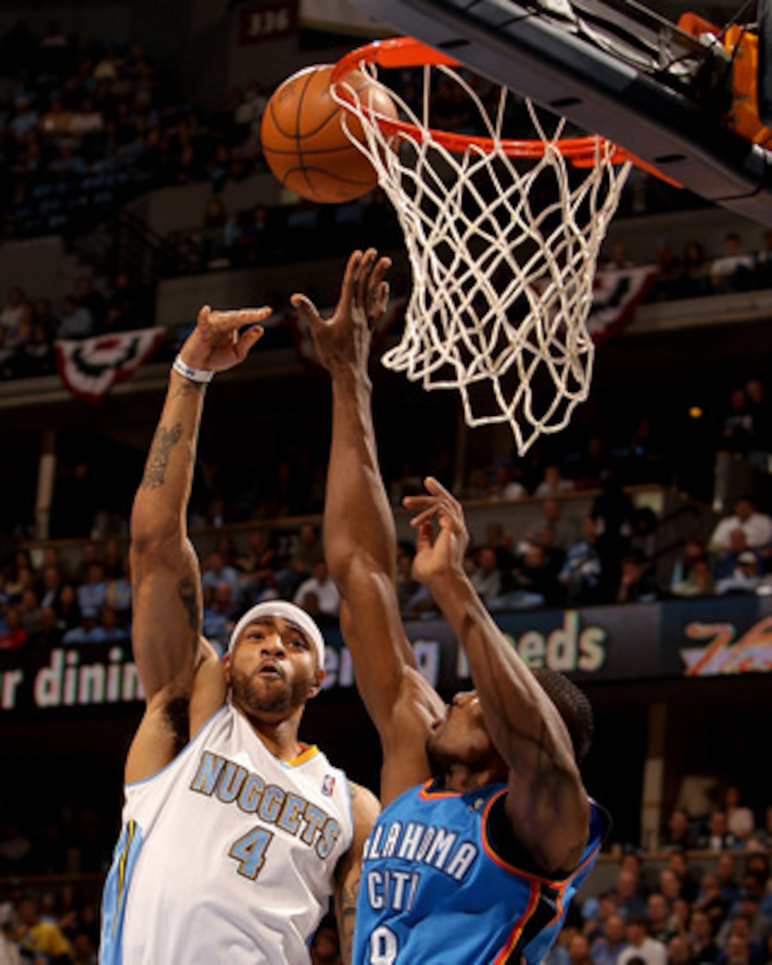 DENVER, CO - APRIL 25:  Kenyon Martin #4 of the Denver Nuggets scores on Serge Ibaka #9 of the Oklahoma City Thunder in Game Four of the Western Conference Quarterfinals in the 2011 NBA Playoffs at Pepsi Center on April 25, 2011 in Denver, Colorado. NOTE 