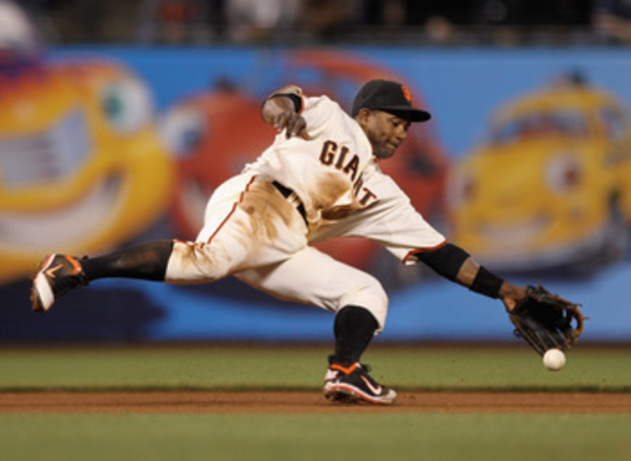 SAN FRANCISCO, CA - MAY 11:  Miguel Tejada #10 of the San Francisco Giants reaches for a ball hit by Ryan Roberts #14 of the Arizona Diamondbacks at AT&T Park on May 11, 2011 in San Francisco, California. Tejada threw Roberts out at first base on the play
