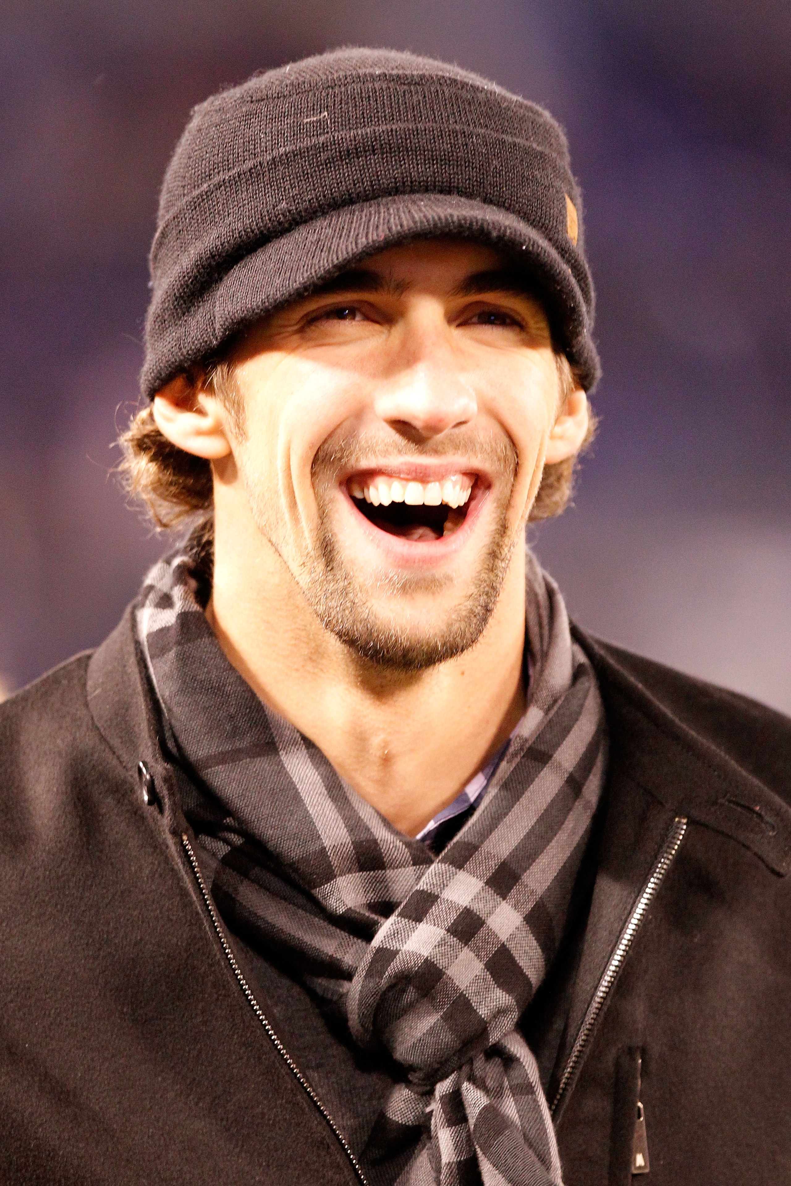BALTIMORE, MD - DECEMBER 05: American swimmer Michael Phelps smiles as he watches the Baltimore Ravens and the Pittsburgh Steelers during the first quarter of the game at M&T Bank Stadium on December 5, 2010 in Baltimore, Maryland. (Photo by Geoff Burke BALTIMORE, MD - DECEMBER 05: American swimmer Michael Phelps smiles as he watches the Baltimore Ravens and the Pittsburgh Steelers during the first quarter of the game at M&T Bank Stadium on December 5, 2010 in Baltimore, Maryland. (Photo by Geoff Burke