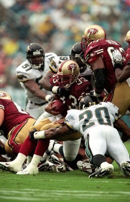 12 Sep 1999:  Lawrence Phillips #33 of the San Francisco 49ers is brought down by Donovin Darius #20 of the Jacksonville Jaguars during the game at Alltell Stadium in Jacksonville, Florida. The Jaguars defeated the 49ers 41-3. Mandatory Credit: Andy Lyons