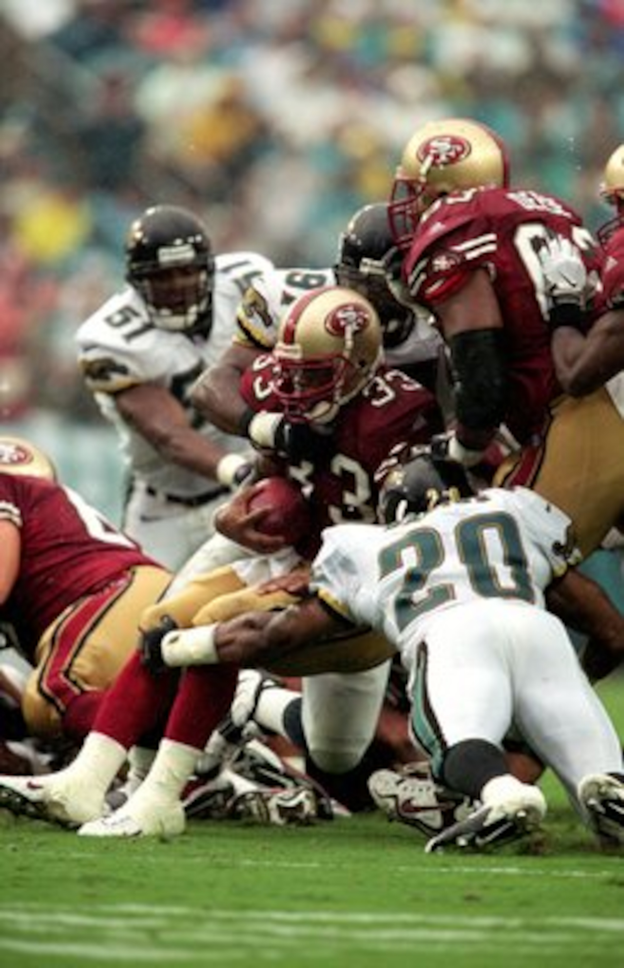 12 Sep 1999:  Lawrence Phillips #33 of the San Francisco 49ers is brought down by Donovin Darius #20 of the Jacksonville Jaguars during the game at Alltell Stadium in Jacksonville, Florida. The Jaguars defeated the 49ers 41-3. Mandatory Credit: Andy Lyons