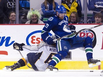 VANCOUVER, CANADA - MAY 7: Daniel Sedin #22 of the Vancouver Canucks gets hauled down by Shea Weber #6 of the Nashville Predators during the second period in Game Five of the Western Conference Semifinals during the 2011 NHL Stanley Cup Playoffs on May 07