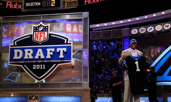 NEW YORK, NY - APRIL 28:  Cam Newton, #1 overall pick by the Carolina Panthers holds up a jersey on stage after he was picked during the 2011 NFL Draft at Radio City Music Hall on April 28, 2011 in New York City.  (Photo by Chris Trotman/Getty Images)