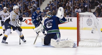 VANCOUVER, CANADA - APRIL 30: Jerred Smithson #25 of the Nashville Predators and Ryan Kesler #17 of the Vancouver Canucks watches the puck shot by Matt Halischuck #24 (not pictured) of the Nashville Predators hit the back of the net after getting past goa