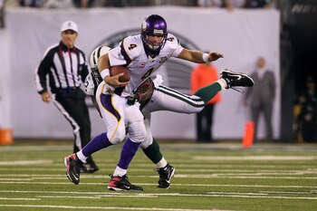 EAST RUTHERFORD, NJ - OCTOBER 11:  Quarterback Brett Favre #4 of the Minnesota Vikings attempts to escape the pressure from Shaun Ellis #92 of the New York Jets at New Meadowlands Stadium on October 11, 2010 in East Rutherford, New Jersey.  (Photo by Jim