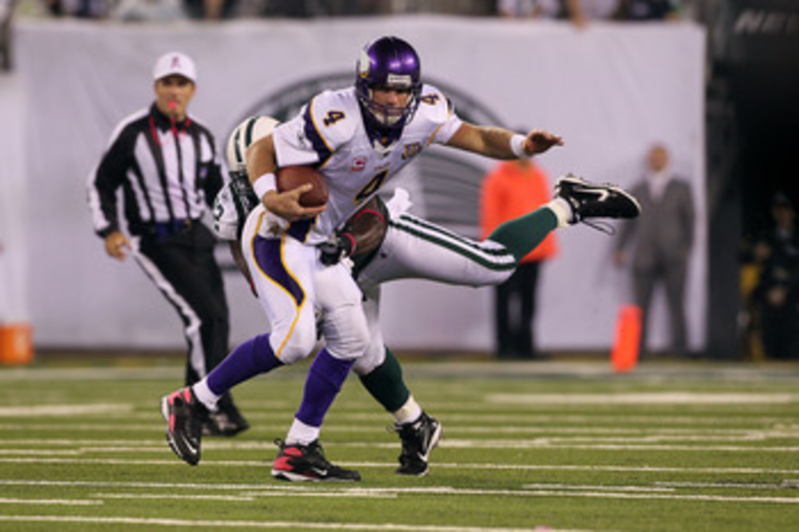 EAST RUTHERFORD, NJ - OCTOBER 11:  Quarterback Brett Favre #4 of the Minnesota Vikings attempts to escape the pressure from Shaun Ellis #92 of the New York Jets at New Meadowlands Stadium on October 11, 2010 in East Rutherford, New Jersey.  (Photo by Jim