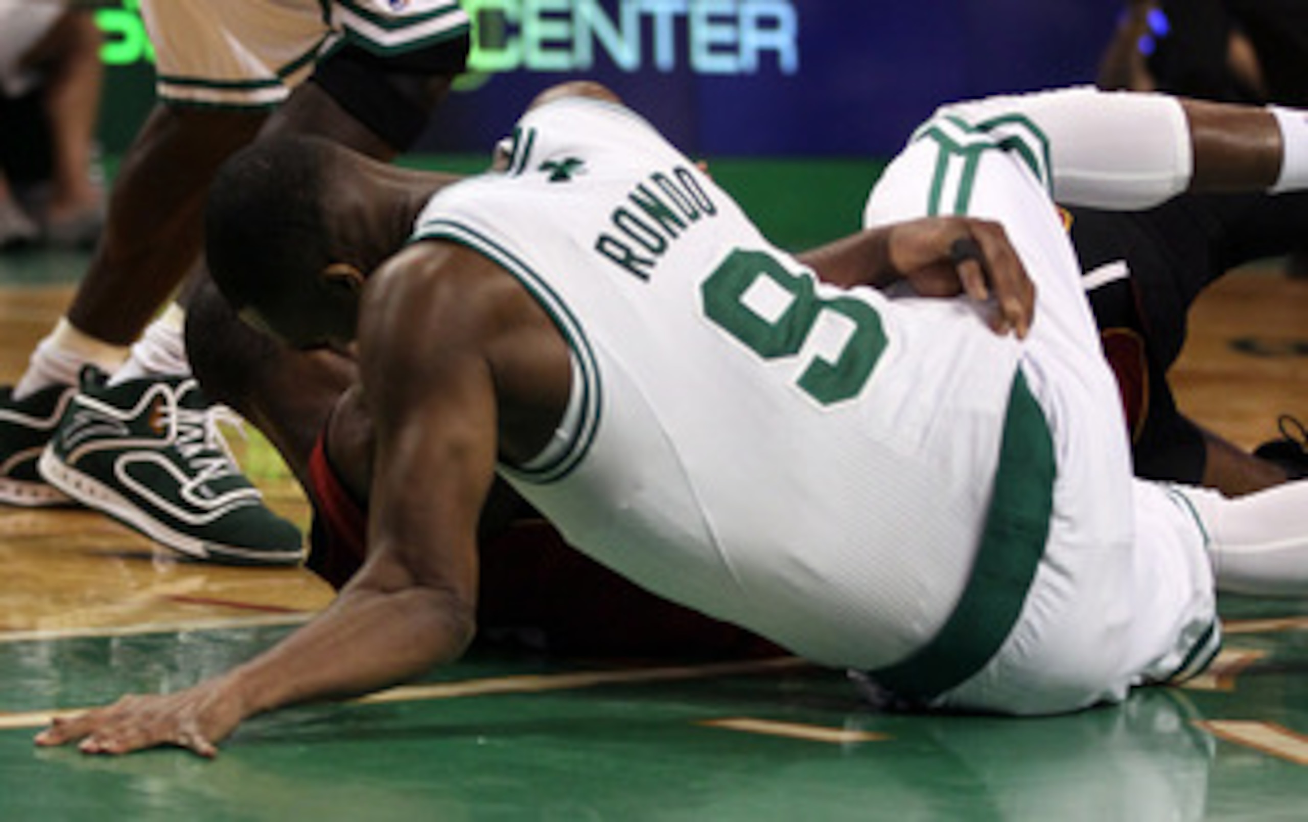 BOSTON, MA - MAY 07: Rajon Rondo #9 of the Boston Celtics injures his arm as he lands on the court after a scramble with Dwyane Wade #3 of the Miami Heat in Game Three of the Eastern Conference Semifinals in the 2011 NBA Playoffs on May 7, 2011 at the TD