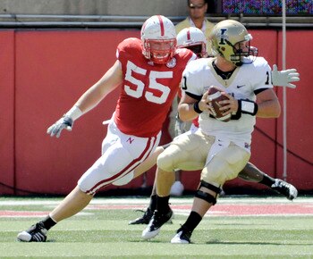 LINCOLN, NEBRASKA - SEPTEMBER 11: Idaho Vandals quarterback Nathan Enderle #10 tries to elude over Nebraska Cornhuskers defensive tackle Baker Steinkuhler #55 during first half action of their game at Memorial Stadium on September 4, 2010 in Lincoln, Nebr