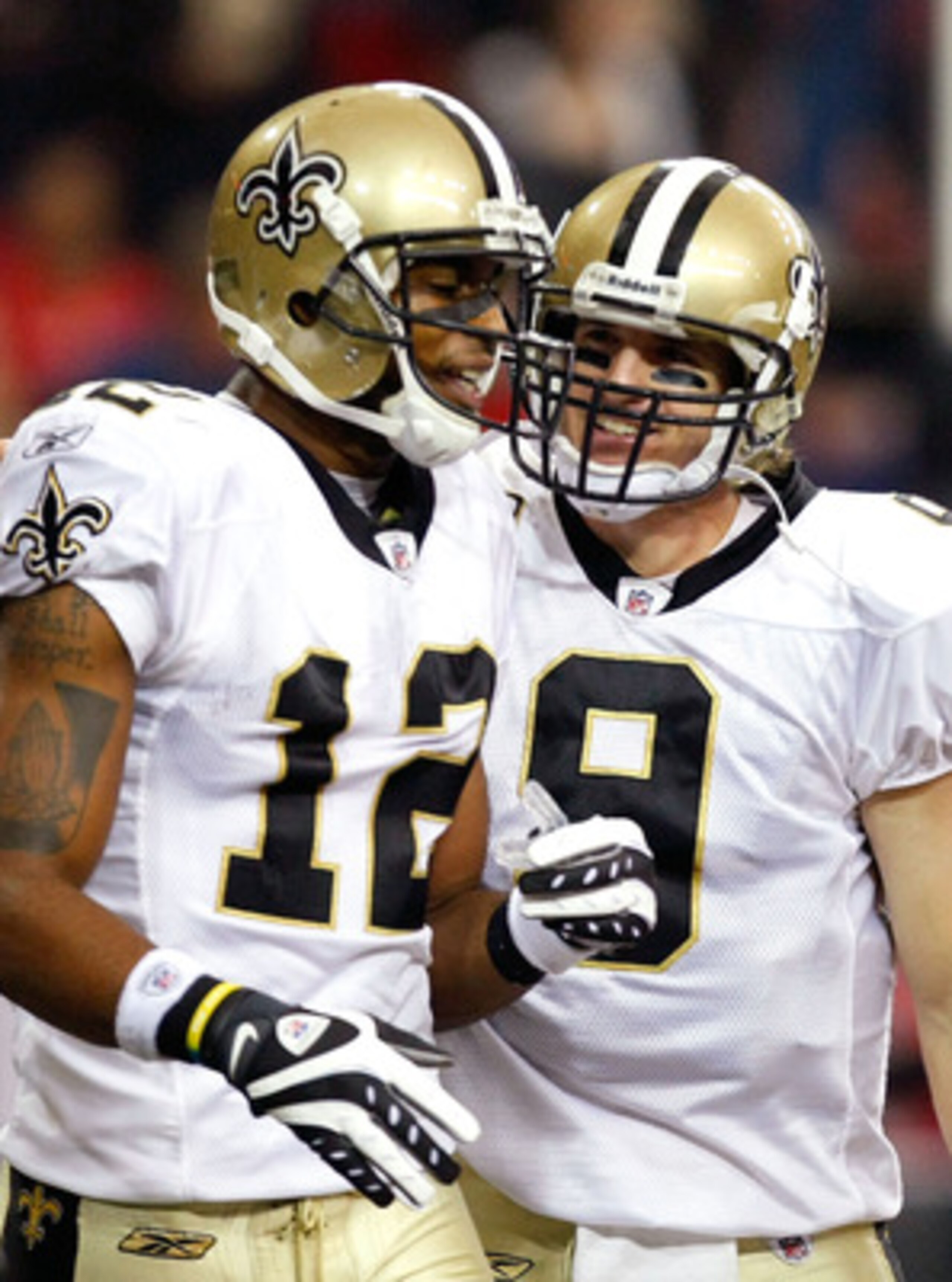 ATLANTA - DECEMBER 13:  Marques Colston #12 and quarterback Drew Brees #9 of the New Orleans Saints celebrate Colston's 3-yard touchdown reception in the second quarter against the Atlanta Falcons at Georgia Dome on December 13, 2009 in Atlanta, Georgia.