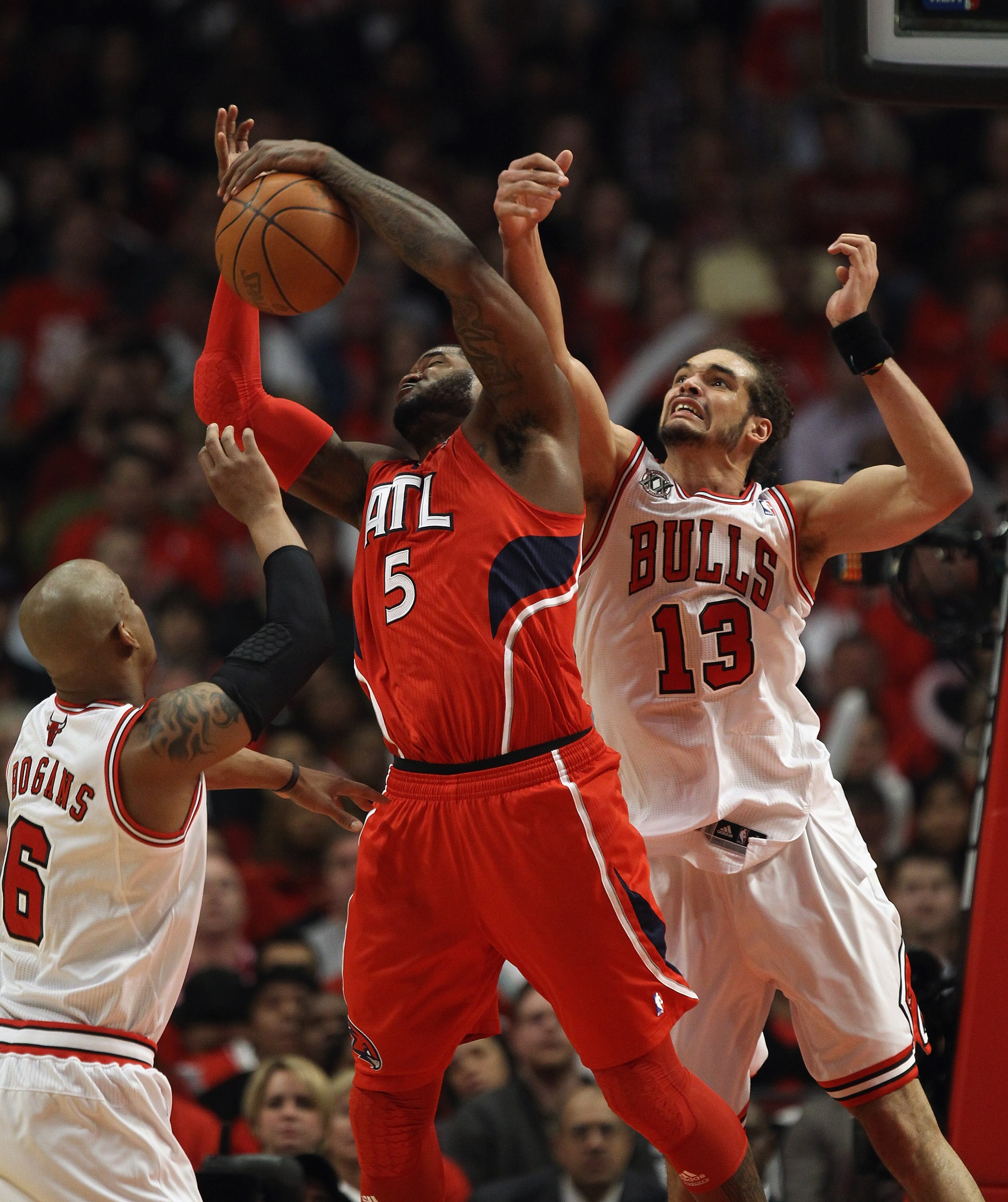 CHICAGO, IL - MAY 04: Josh Smith #5 of the Atlanta Hawks grabs a rebound between Keith Bogans #6 and Joakim Noah #13 of the Chicago Bulls in Game Two of the Eastern Conference Semifinals in the 2011 NBA Playoffs at the United Center on May 4, 2011 in Chic