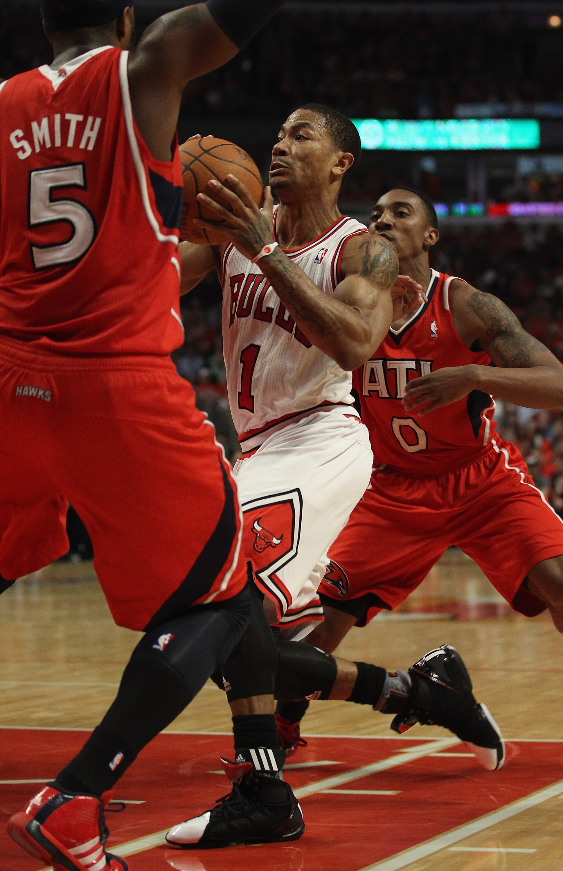 CHICAGO, IL - MAY 10: Derrick Rose #1 of the Chicago Bulls drives between Josh Smith #5 and Jeff Teague #0 of the Atlanta Hawks in Game Five of the Eastern Conference Semifinals in the 2011 NBA Playoffs at the United Center on May 10, 2011 in Chicago, Ill