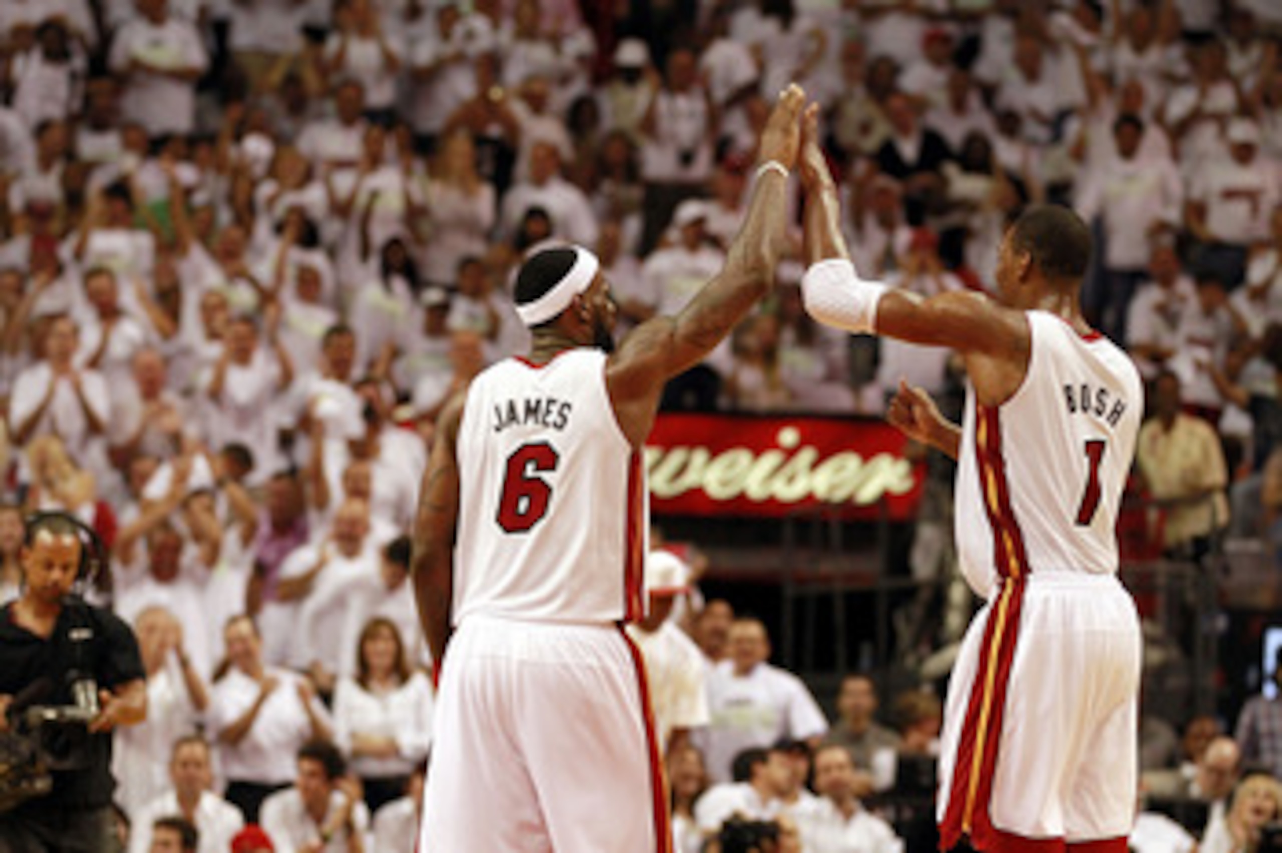 MIAMI, FL - APRIL 16:  Forward Chris Bosh #1 of the  Miami Heat celebrates with teammate LeBron James #6 after a dunk against the Philadelphia 76ers at the American Airlines Arena in game one of the Eastern Conference Quarterfinals in the 2011 NBA Playoff