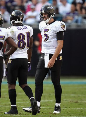 CHARLOTTE, NC - NOVEMBER 21:  Joe Flacco #5 of the Baltimore Ravens talks to his wide receivers Derrick Mason #85 and Anquan Boldin #81 during a timeout against the Carolina Panthers at Bank of America Stadium on November 21, 2010 in Charlotte, North Caro
