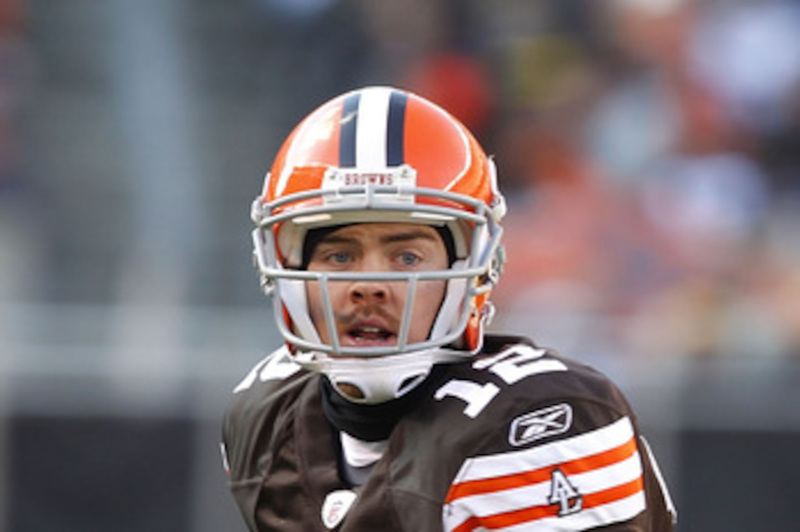 CLEVELAND, OH - JANUARY 02:  Quarterback Colt McCoy #12 of the Cleveland Browns looks for a receiver as he is chased by defensive end Ziggy Hood #96 of the Pittsburgh Steelers at Cleveland Browns Stadium on January 2, 2011 in Cleveland, Ohio.  (Photo by M