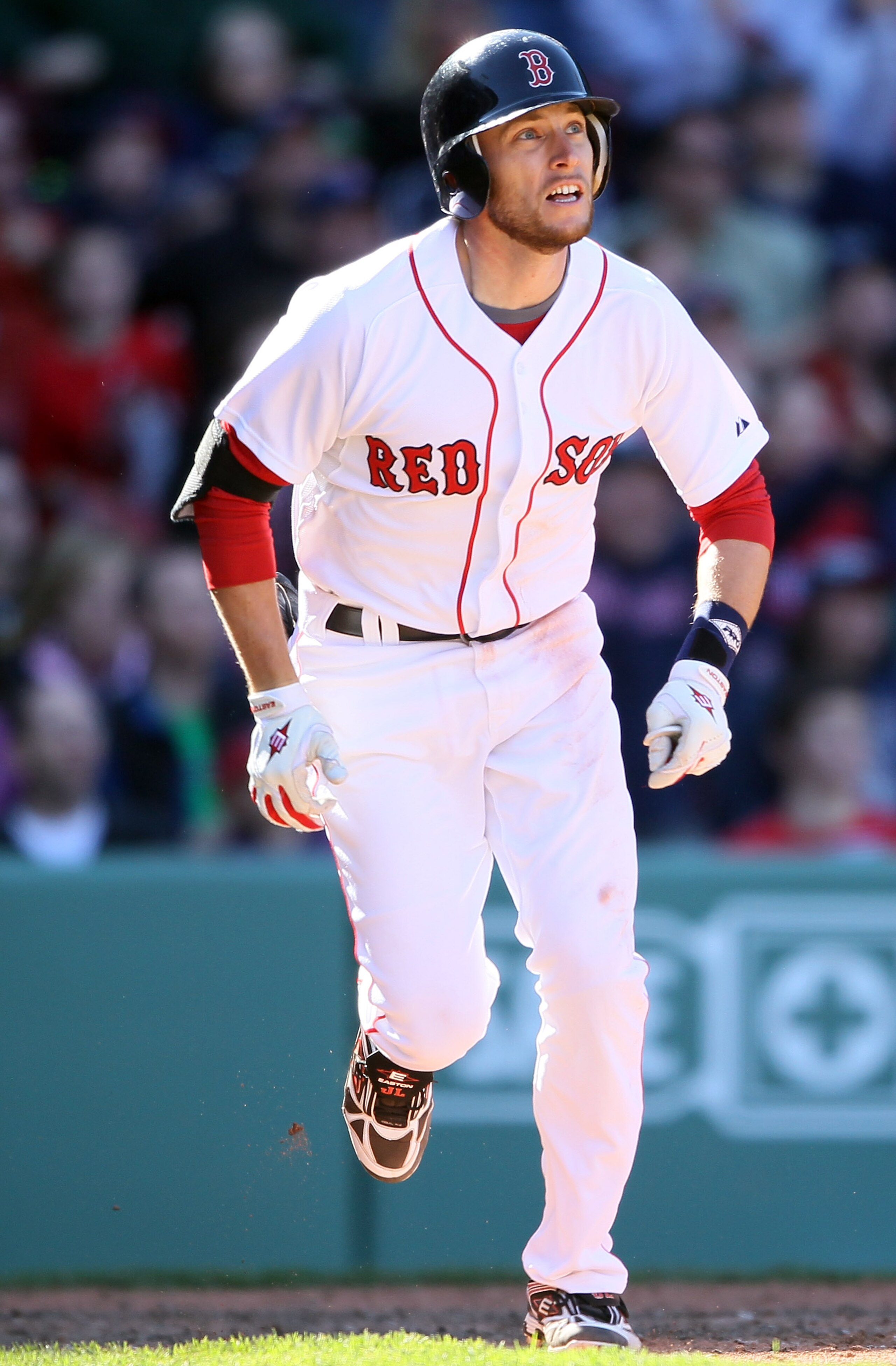BOSTON, MA - MAY 01:  Jed Lowrie #12 of the Boston Red Sox heads for first after he hit a triple in the bottom of the ninth inning against the Seattle Mariners on May 1, 2011 at Fenway Park in Boston, Massachusetts. Lowrie would score on a hit by Carl Cra
