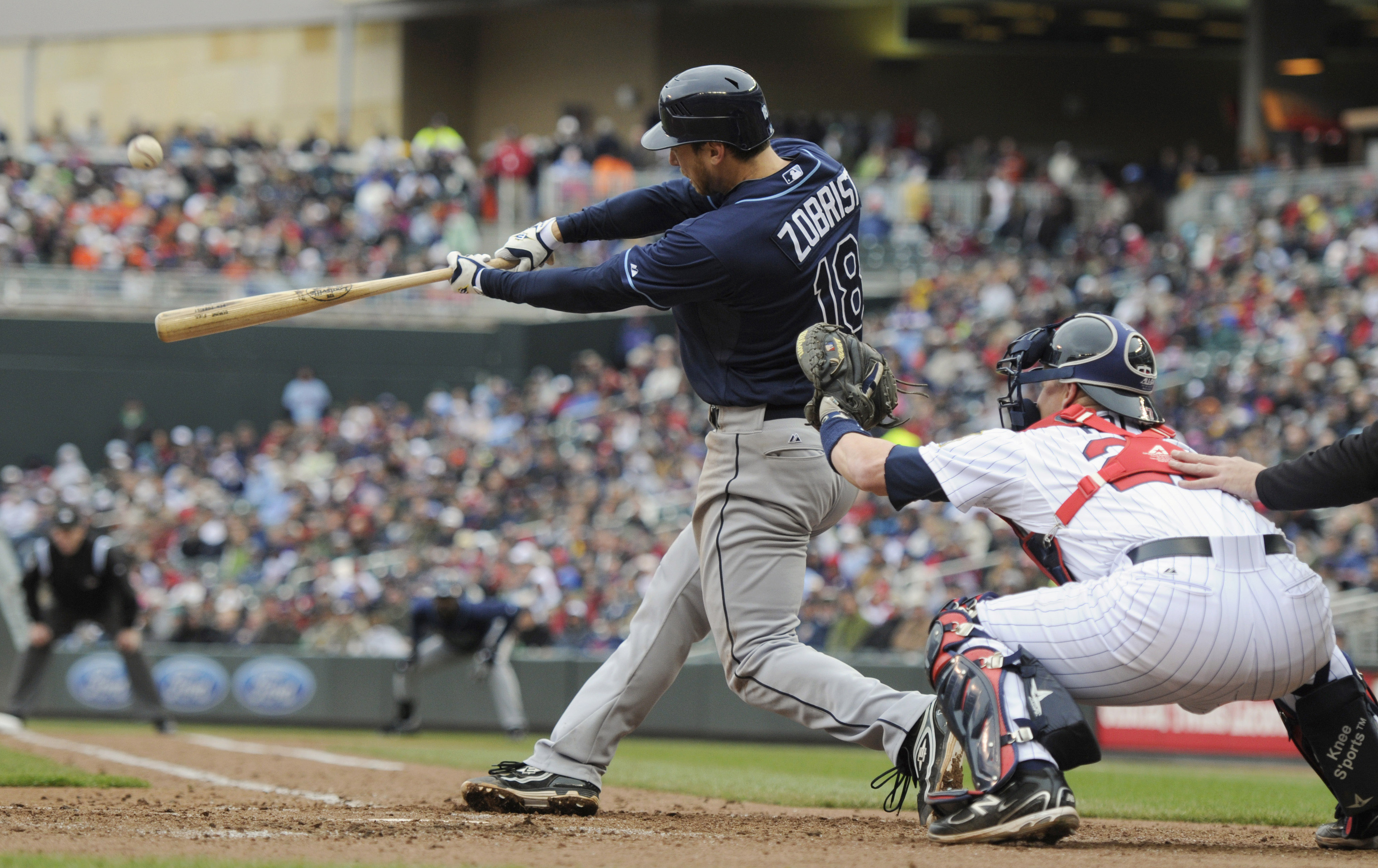 MINNEAPOLIS, MN - APRIL 28: Ben Zobrist #18 of the Tampa Bay Rays hits a three-run home run while Steve Holm #27 of the Minnesota Twins defends home plate during in the sixth inning of their game on April 28, 2011 at Target Field in Minneapolis, Minnesota