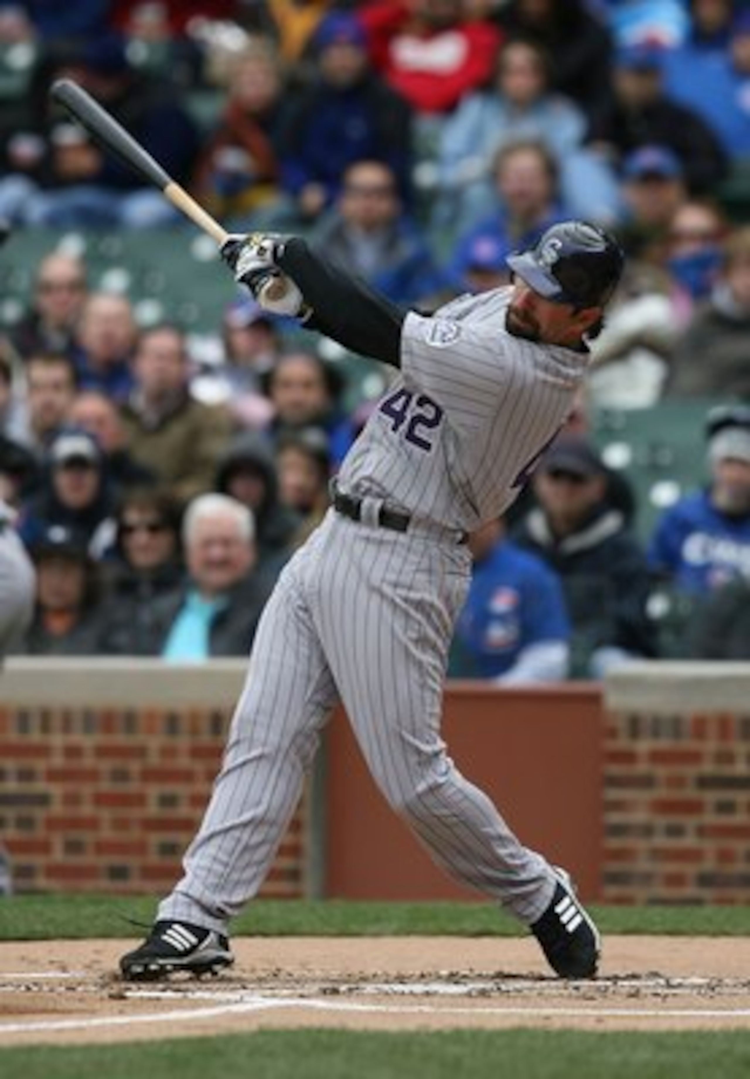CHICAGO - APRIL 15: Todd Helton of the Colorado Rockies, wearing a #42 jersey on Jackie Robinson Day, swings the bat against the Chicago Cubs on April 15, 2009 at Wrigley Field in Chicago, Illinois. The Rockies defeated the Cubs 5-2. (Photo by Jonathan Da