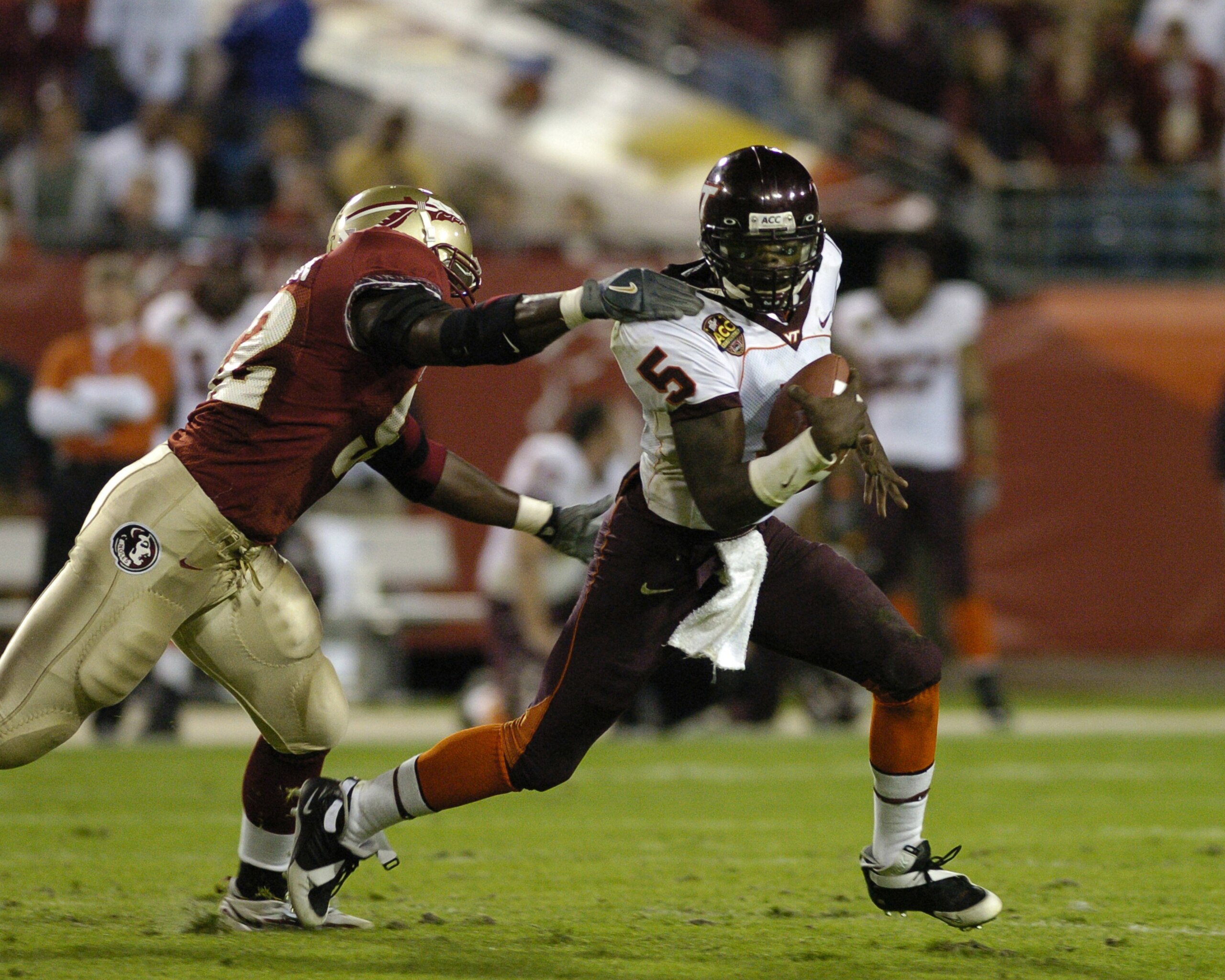 Virginia Tech quarterback Marcus Vick scrambles from the Florida State  pass rush  at  the 2005 ACC Football Championship Game on December 3, 2005 in Jacksonville, Florida. FSU upset Virginia Tech 27 - 22 to win the ACC championship. (Photo by A. Messersc