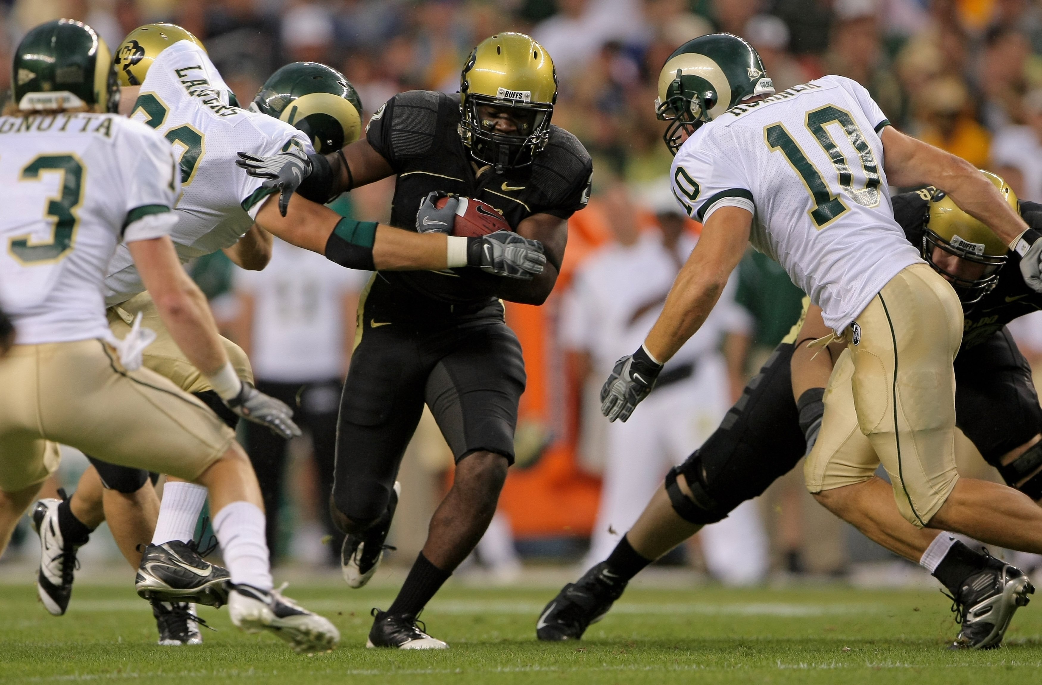 DENVER - AUGUST 31:  Running back Darrell Scott #2 of the University of Colorado Buffaloes rushes as Jeff Horinek #10 and Wade Landers #93 of the Colorado State University Rams defend at Invesco Field at Mile High on August 31, 2008 in Denver, Colorado. C
