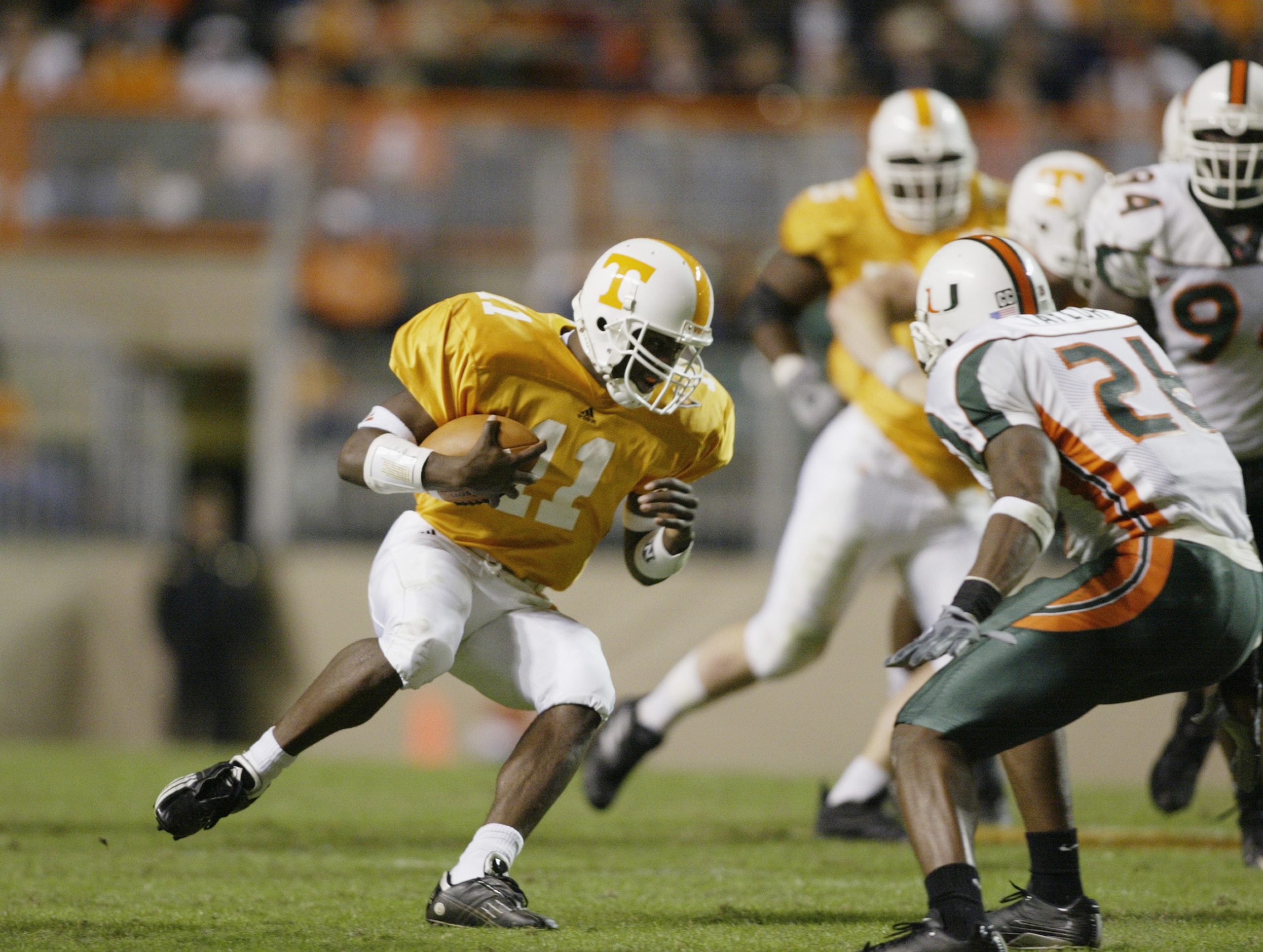 KNOXVILLE,TN - NOVEMBER 9:  Quaterback James Banks #11 of the Tennessee scrambles with the ball during the game against Miami on November 9, 2002 at the Neyland Stadium in Knoxville, Tennessee.  (Photo by Andy Lyons/Getty Images)