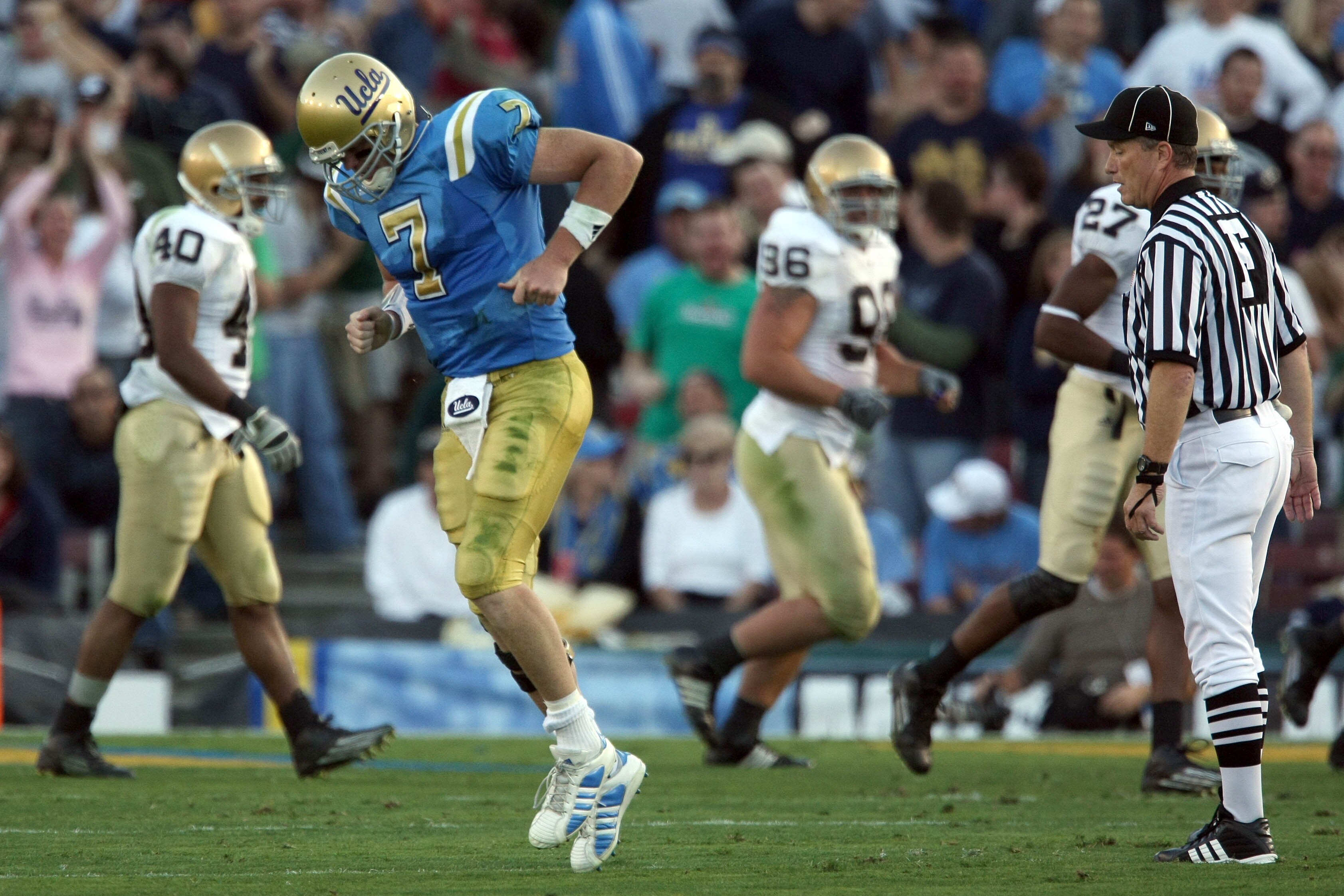 PASADENA, CA - OCTOBER 6:  Quarterback Ben Olson #7 of the UCLA Bruins limps off the field during their NCAA Football game against the Notre Dame Fighting Irish at the Rose Bowl October 6, 2007 in Pasadena, California.  (Photo by Donald Miralle/Getty Imag