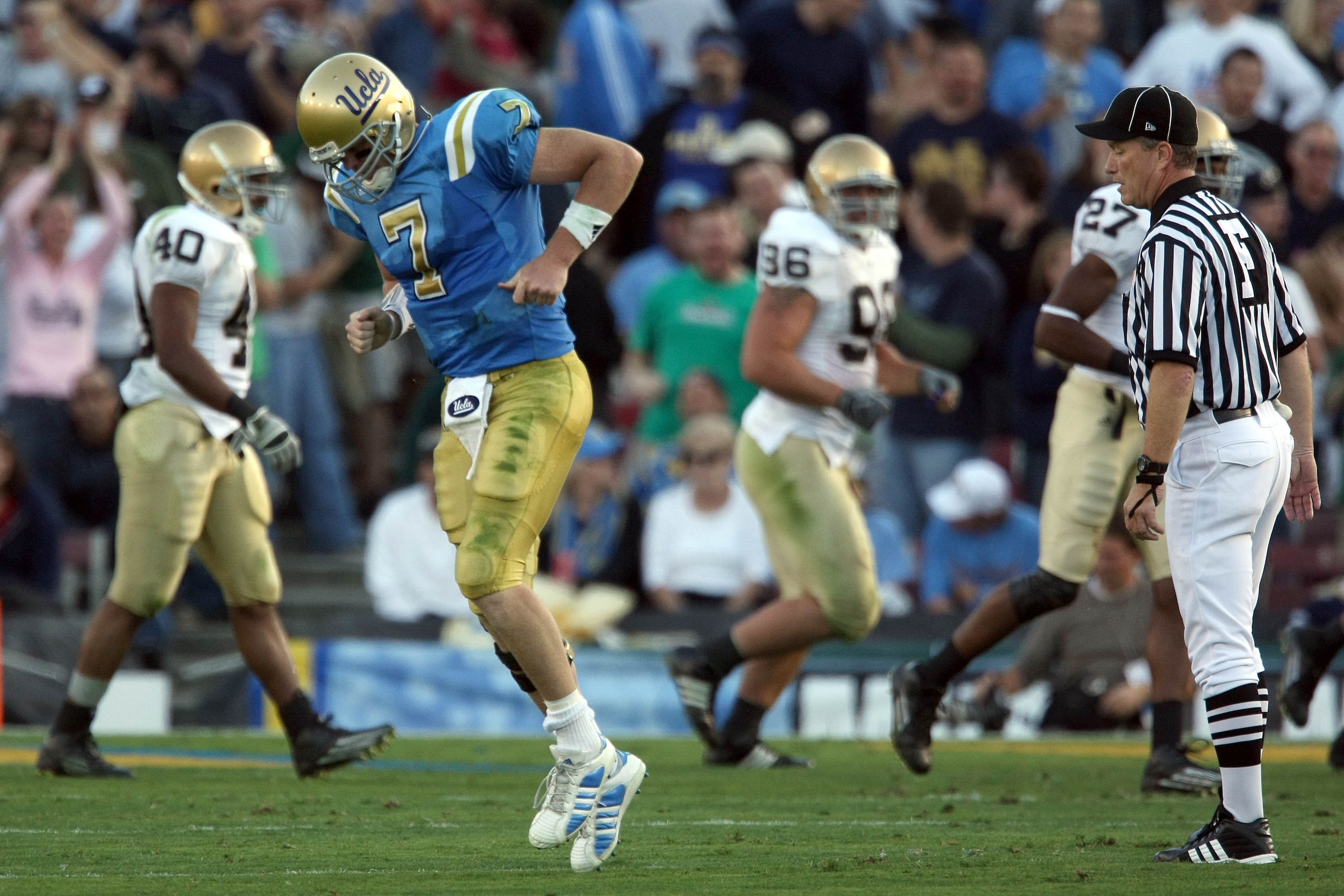 PASADENA, CA - OCTOBER 6:  Quarterback Ben Olson #7 of the UCLA Bruins limps off the field during their NCAA Football game against the Notre Dame Fighting Irish at the Rose Bowl October 6, 2007 in Pasadena, California.  (Photo by Donald Miralle/Getty Imag