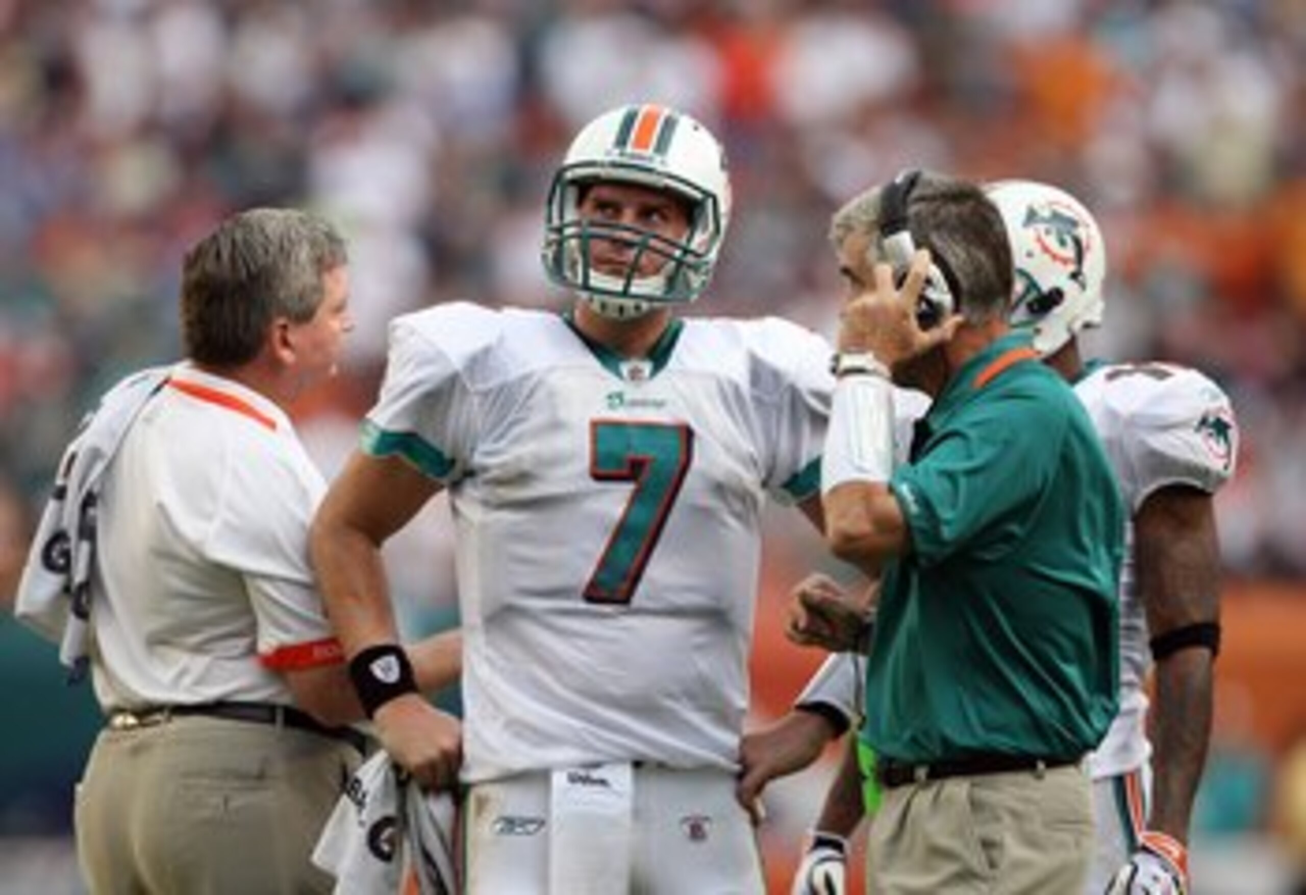 MIAMI - DECEMBER 06:  Quarterback Chad Henne #7 of the Miami Dolphins talks with offensive coordinator Dan Henning on the sideline after calling a time-out during the game-winning drive against the New England Patriots at Land Shark Stadium on December 6,