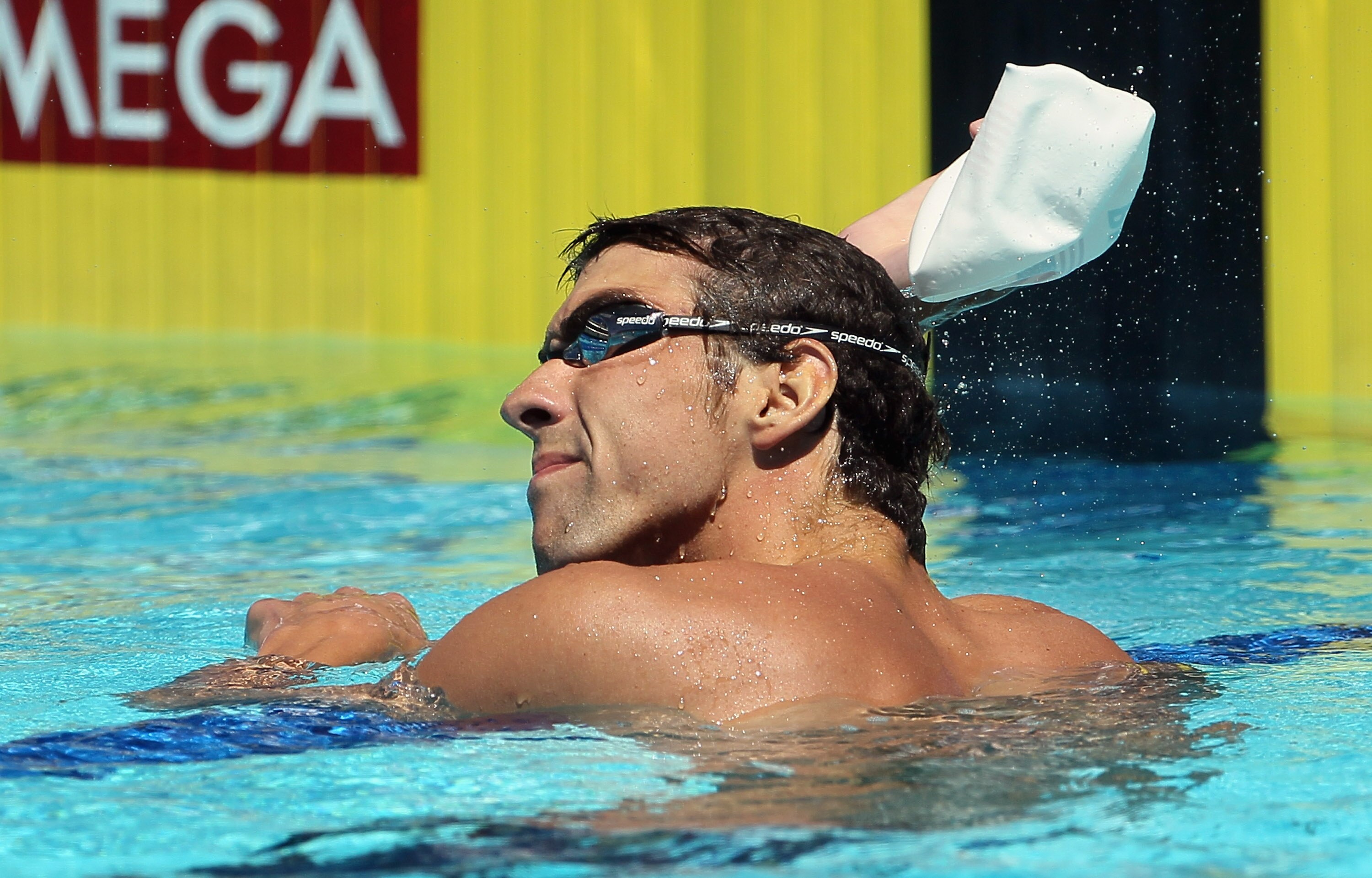 IRVINE, CA - AUGUST 19:  Michael Phelps takes his cap off after competing in the men's 400 IM preliminary heat during the Mutual of Omaha Pan Pacific Championships at the William Woollett Jr. Aquatic Center on August 19, 2010 in Irvine, California.  (Phot