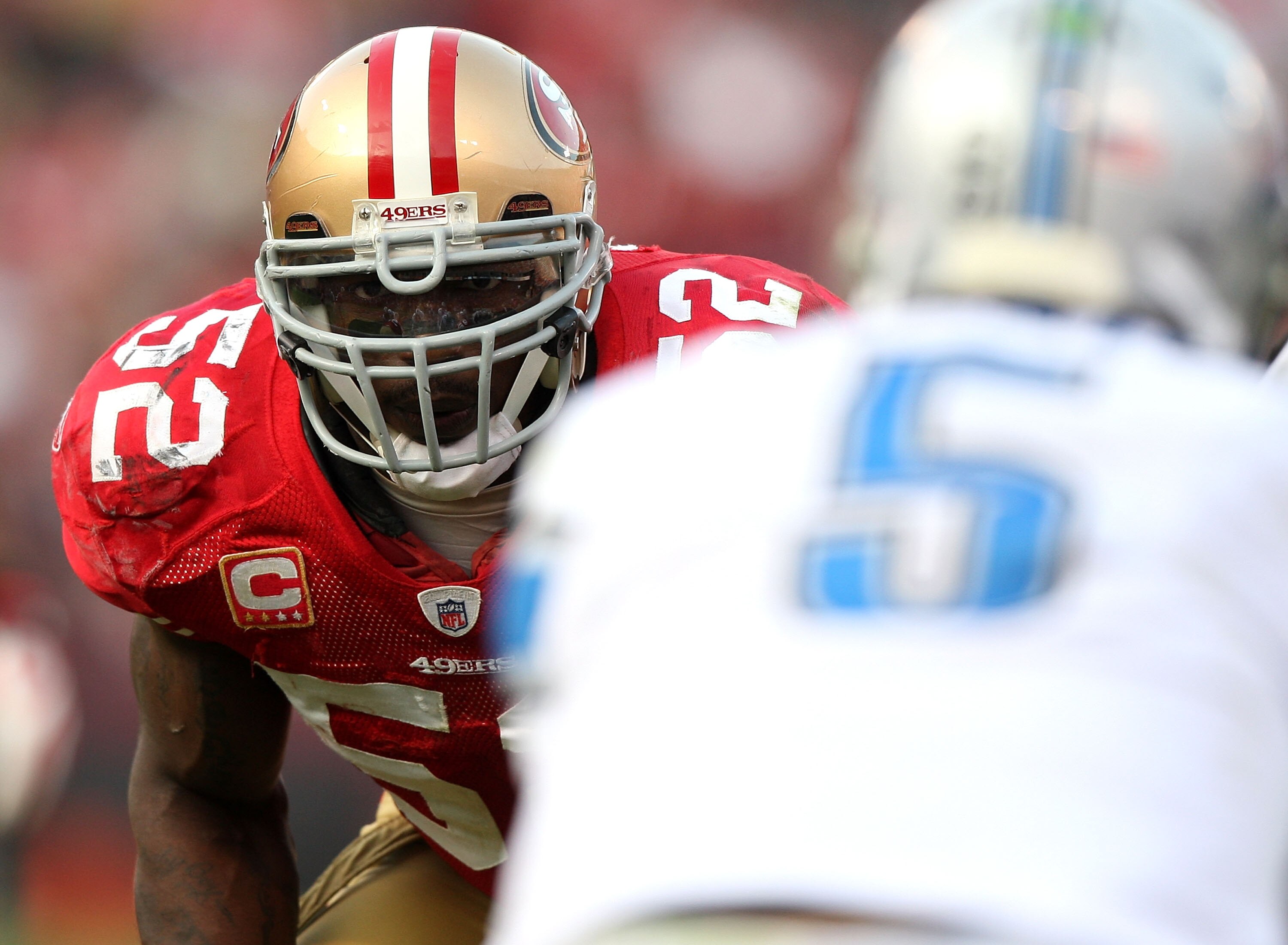 SAN FRANCISCO - DECEMBER 27: Patrick Willis #52 of the San Francisco 49ers eyes quarterback Drew Stanton #5 of the Detroit Lions before a play during an NFL game at Candlestick Park on December 27, 2009 in San Francisco, California.  (Photo by Jed Jacobso