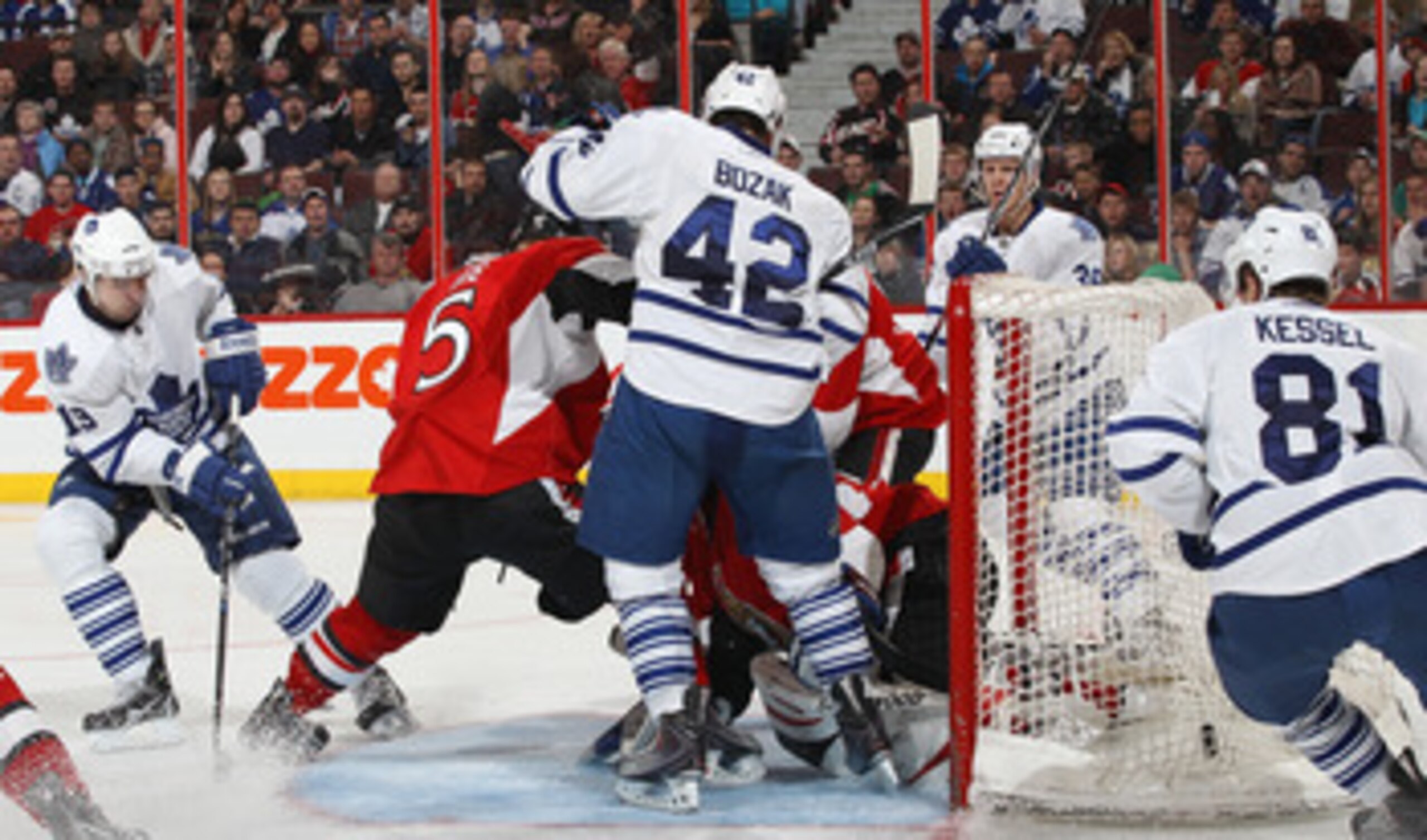 OTTAWA, CANADA - APRIL 2: Brian Lee #5 and team mate Craig Anderson #41 of the Ottawa Senators scramble as Tyler Bozak #42 of the Toronto Maple Leafs tips the puck in the net as team mates Joffrey Lupul #19 Phil Kessel #81Carl Gunnarsson #36 look on at Sc