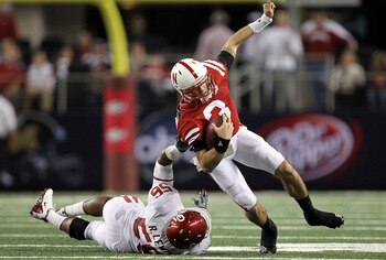 ARLINGTON, TX - DECEMBER 04:  Quarterback Taylor Martinez #3 of the Nebraska Cornhuskers is tackled by Ronnell Lewis #56 of the Oklahoma Sooners during the Big 12 Championship at Cowboys Stadium on December 4, 2010 in Arlington, Texas.  (Photo by Ronald M