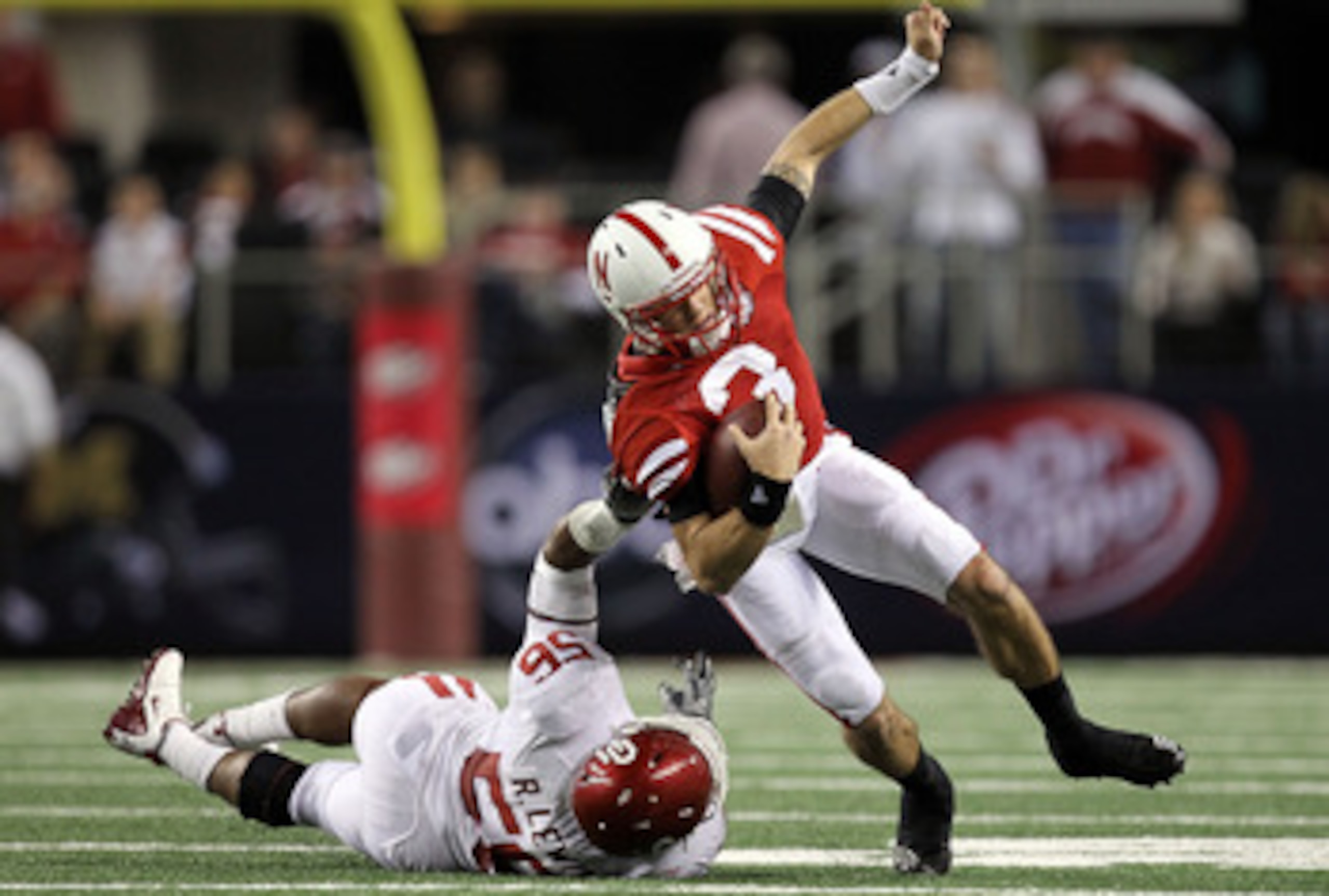 ARLINGTON, TX - DECEMBER 04: Quarterback Taylor Martinez #3 of the Nebraska Cornhuskers is tackled by Ronnell Lewis #56 of the Oklahoma Sooners during the Big 12 Championship at Cowboys Stadium on December 4, 2010 in Arlington, Texas. (Photo by Ronald M ARLINGTON, TX - DECEMBER 04: Quarterback Taylor Martinez #3 of the Nebraska Cornhuskers is tackled by Ronnell Lewis #56 of the Oklahoma Sooners during the Big 12 Championship at Cowboys Stadium on December 4, 2010 in Arlington, Texas. (Photo by Ronald M