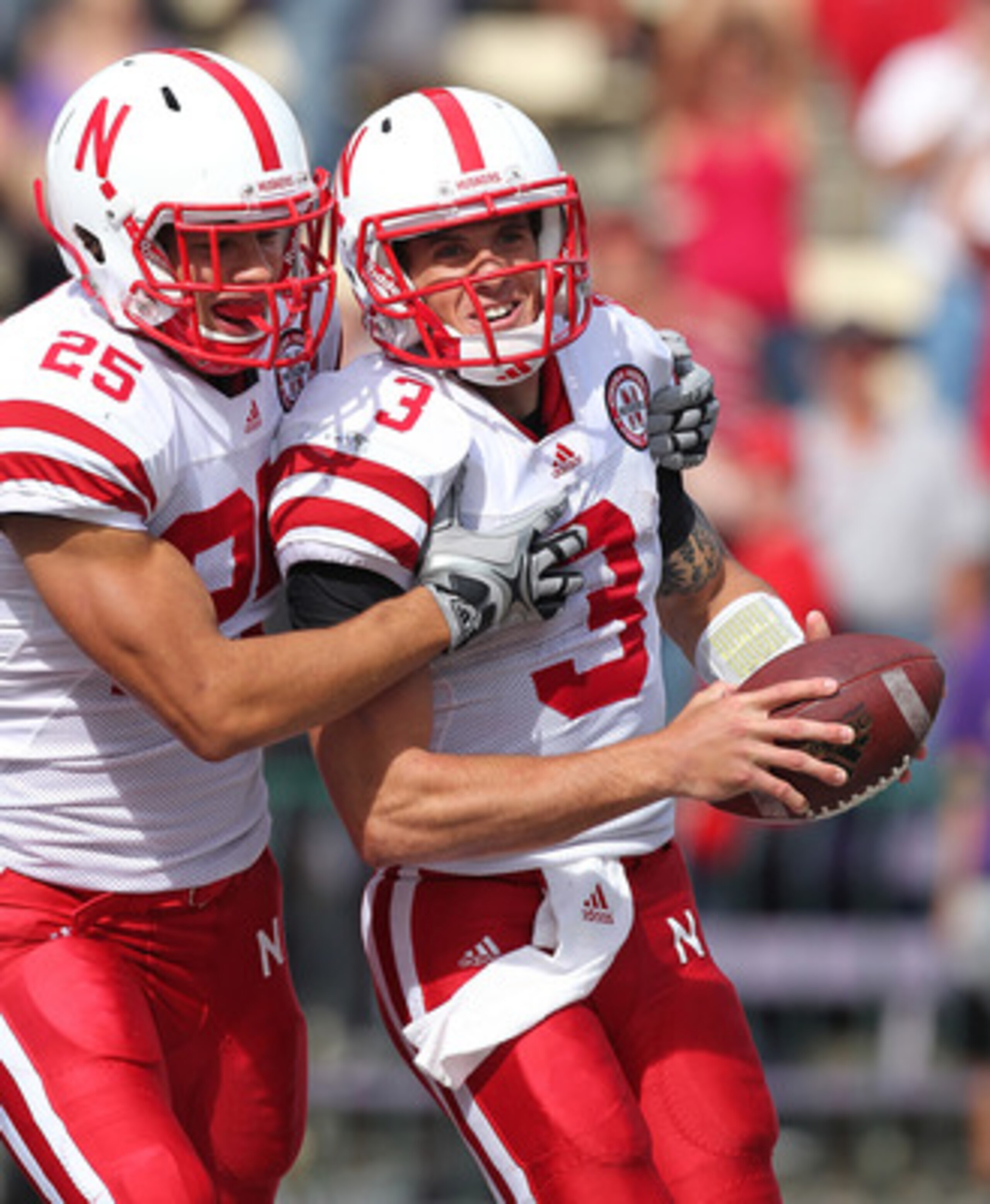 SEATTLE - SEPTEMBER 18: Quarterback Taylor Martinez #3 of the Nebraska Cornhuskers celebrates with Kyler Reed #25 after scoring on an 80 yard touchdown run in the third quarter against the Washington Huskies on September 18, 2010 at Husky Stadium in Seat SEATTLE - SEPTEMBER 18: Quarterback Taylor Martinez #3 of the Nebraska Cornhuskers celebrates with Kyler Reed #25 after scoring on an 80 yard touchdown run in the third quarter against the Washington Huskies on September 18, 2010 at Husky Stadium in Seat