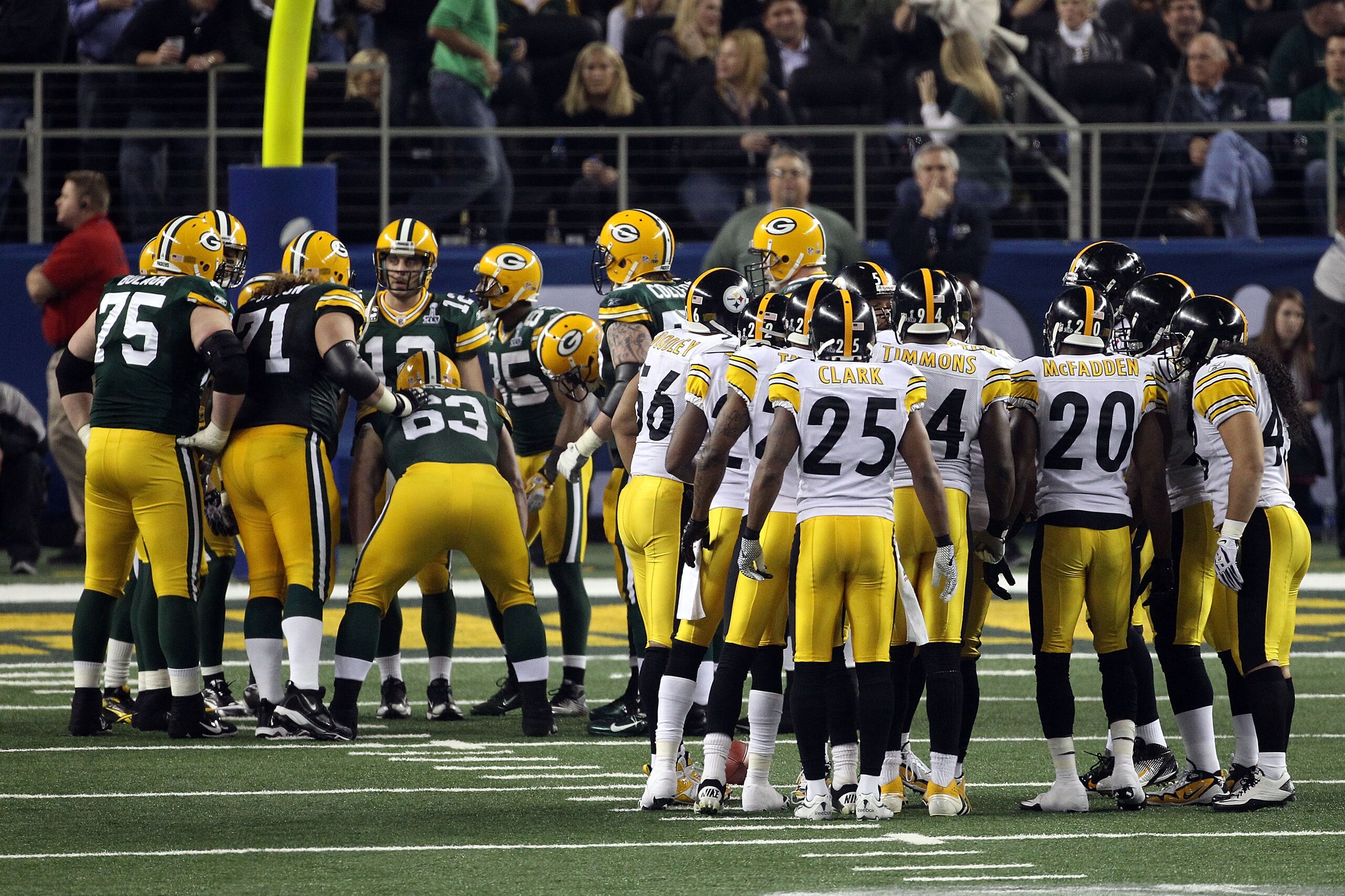 ARLINGTON, TX - FEBRUARY 06: Aaron Rodgers #12 of the Green Bay Packers huddles up with his teammates on offense against the Pittsburgh Steelers defense during Super Bowl XLV at Cowboys Stadium on February 6, 2011 in Arlington, Texas. (Photo by Streeter ARLINGTON, TX - FEBRUARY 06: Aaron Rodgers #12 of the Green Bay Packers huddles up with his teammates on offense against the Pittsburgh Steelers defense during Super Bowl XLV at Cowboys Stadium on February 6, 2011 in Arlington, Texas. (Photo by Streeter