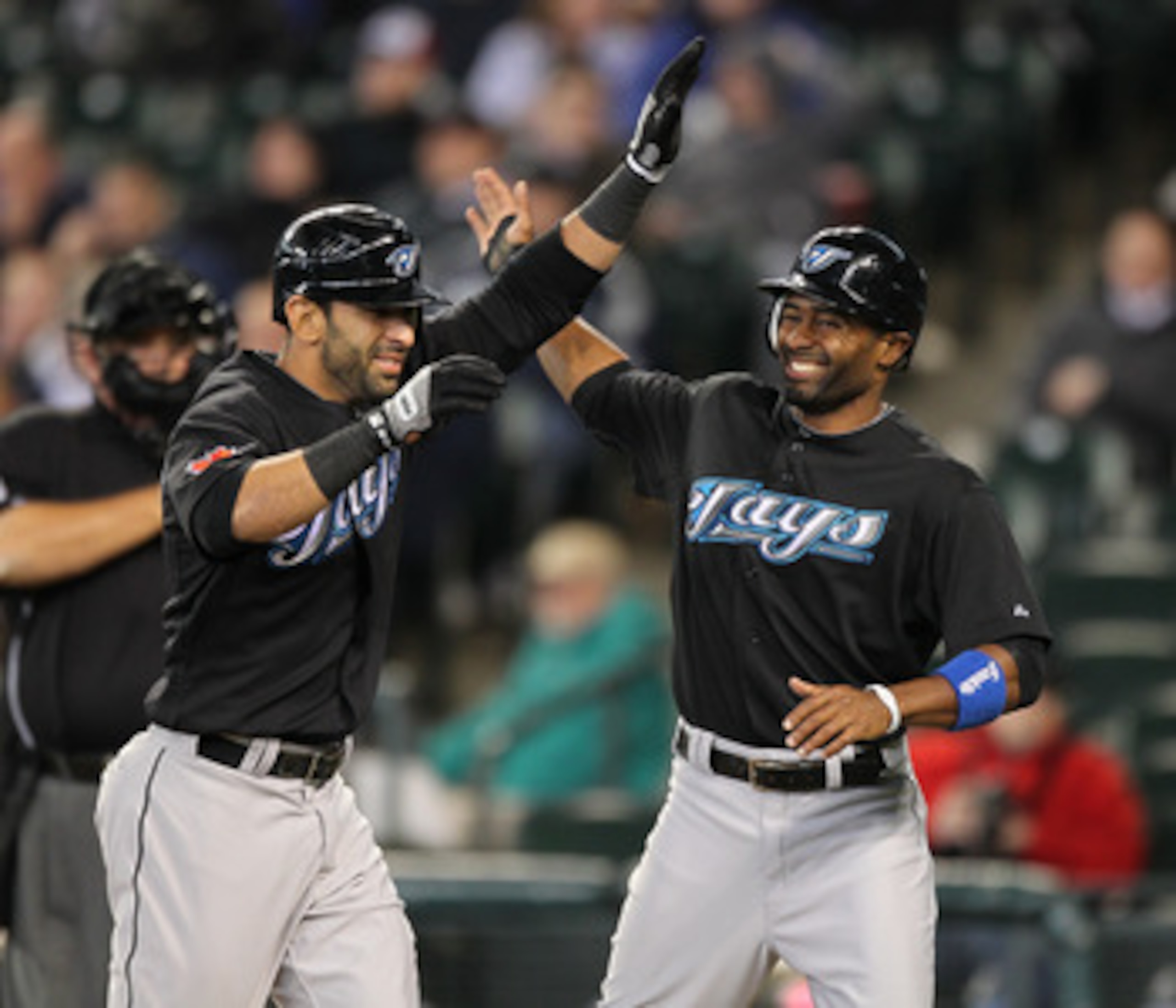 SEATTLE - APRIL 13:  Jose Bautista #19 (L) of the Toronto Blue Jays is congratulated by Corey Patterson #16 after hitting a three-run homer in the eighth inning against the Seattle Mariners at Safeco Field on April 13, 2011 in Seattle, Washington. (Photo 