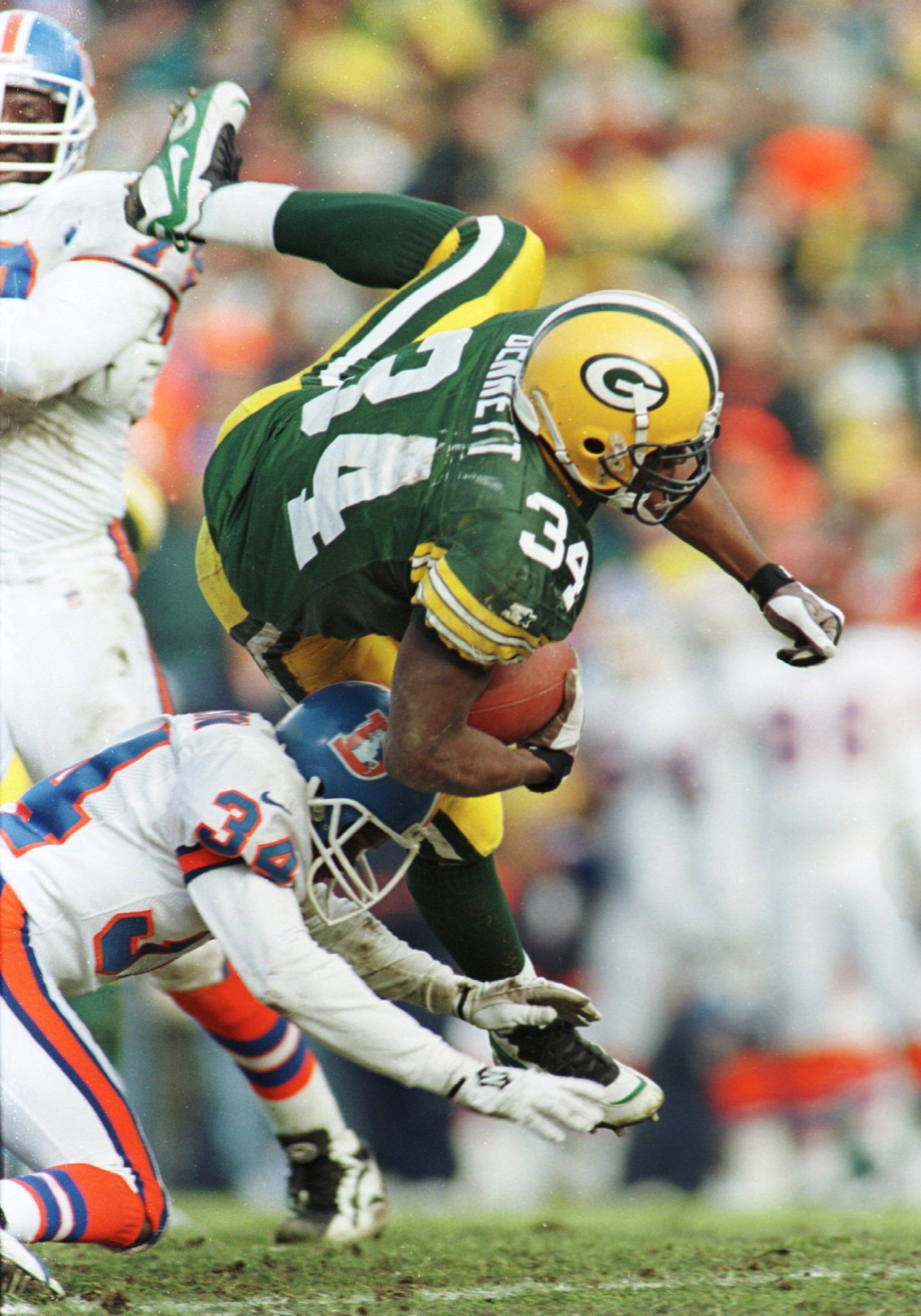 8 Dec 1996:  Running back Edgar Bennett #34  of the Green Bay Packers runs over Tyrone Braxton #34 of the Denver Broncos during the first half of their game  at Lambeau Field in Green Bay, Wisconsin. Mandatory Credit: Brian Bahr/Allsport