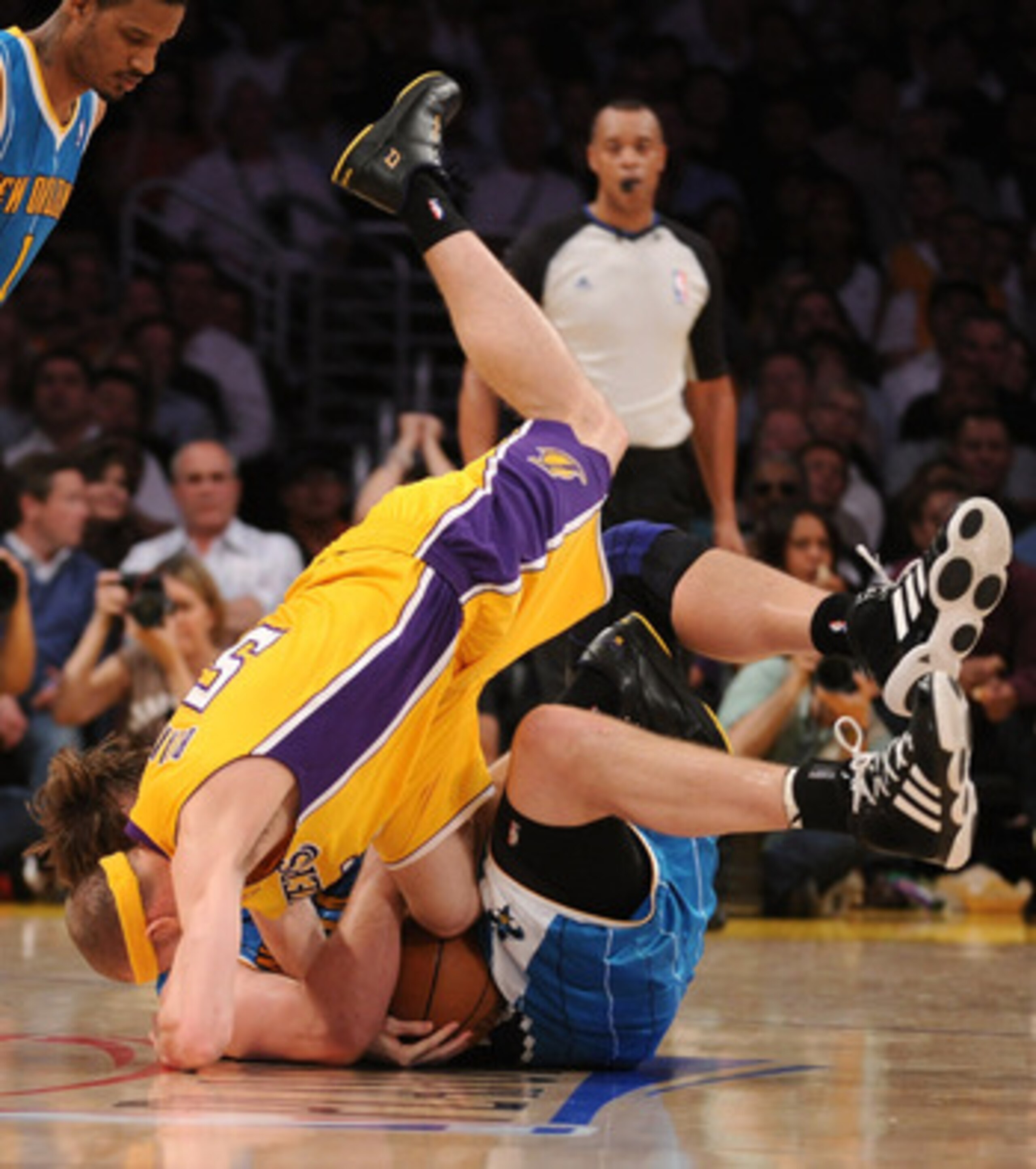 LOS ANGELES, CA - APRIL 26:  Steve Blake #5 of the Los Angeles Lakers goes after the ball held by Aaron Gray #34 of the New Orleans Hornets on the floor in the first half in Game Five of the Western Conference Quarterfinals in the 2011 NBA Playoffs on Apr