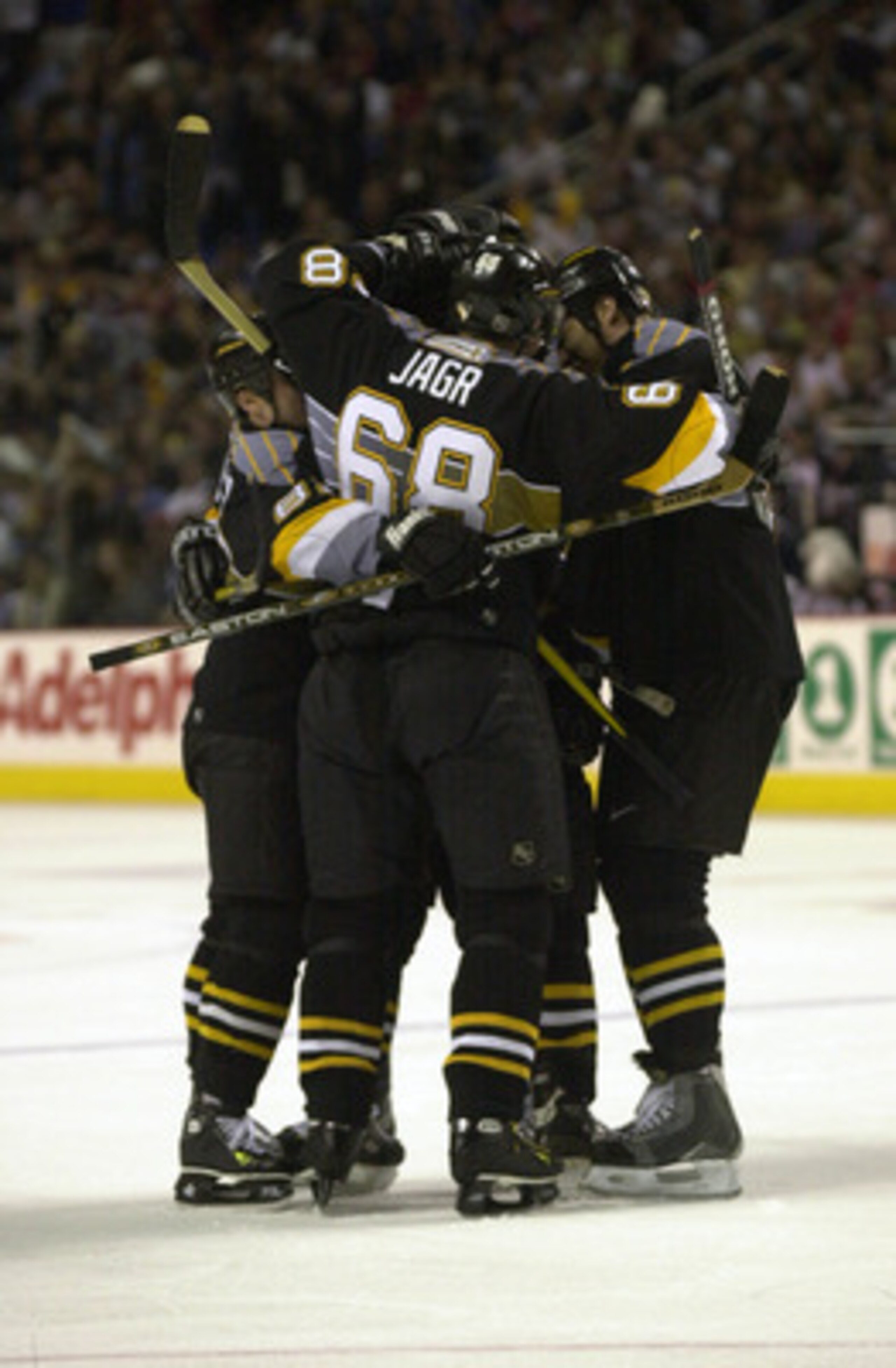 10 May 2001:  Jaromir Jagr #68 of the Pittsburgh Penguins and teammates huddle in celebration after scoring against the Buffalo Sabres during game 7 of the Eastern Conference Semi Finals of the Stanley Cup Playoffs at the HSBC Arena in Buffalo, New York. 