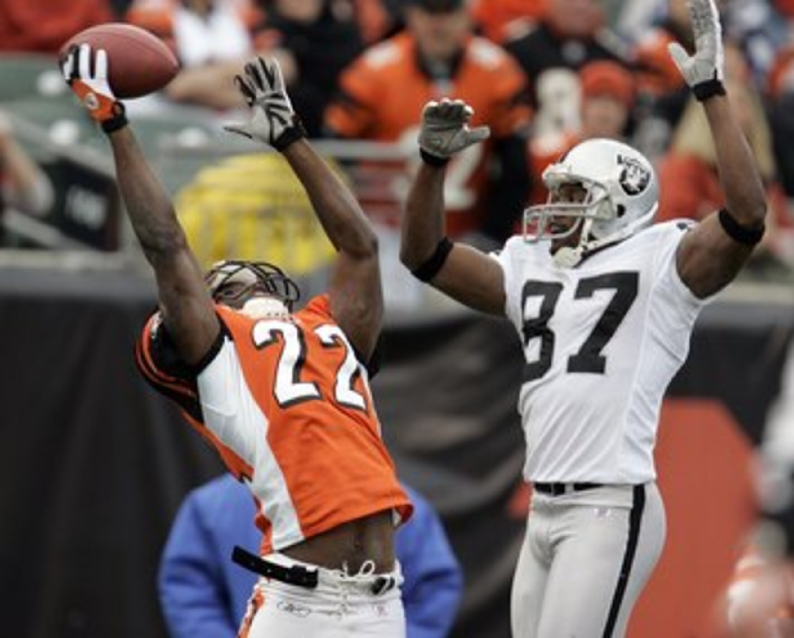 CINCINNATI, OH - DECEMBER 10:  Jonathan Joseph #22 of the Cincinnati Bengals almost intercepts a pass intended for Alvis Whitted #87 of the Oakland Raiders during the second quarter on December 10, 2006 at Paul Brown Stadium in Cincinnati, Ohio.  The Beng