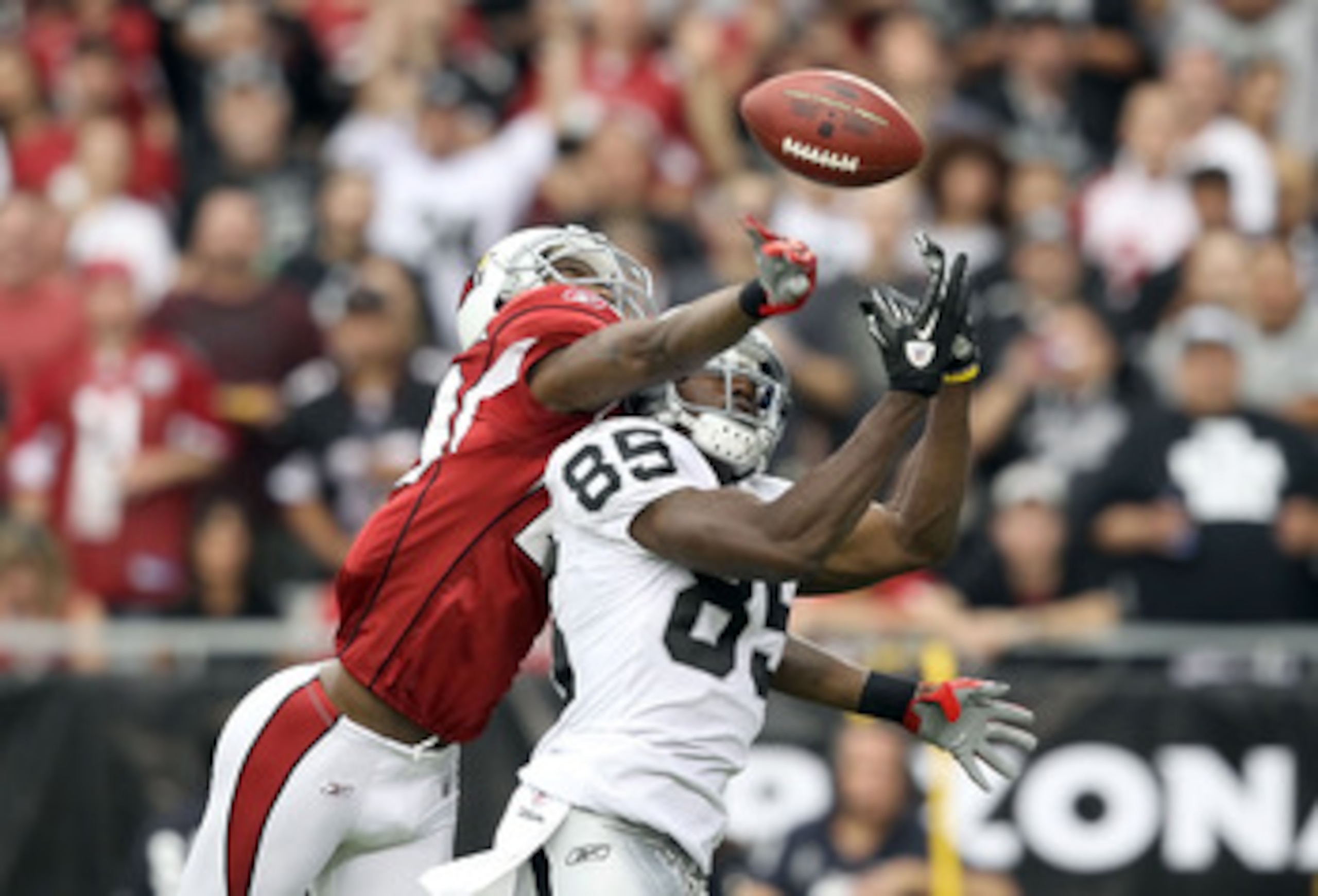 GLENDALE, AZ - SEPTEMBER 26:  Wide receiver Darrius Heyward-Bey #85 of the Oakland Raiders has the ball knocked away by Dominique Rodgers-Cromartie #29 of the Arizona Cardinals during the thrid quarter of the NFL game at the University of Phoenix Stadium